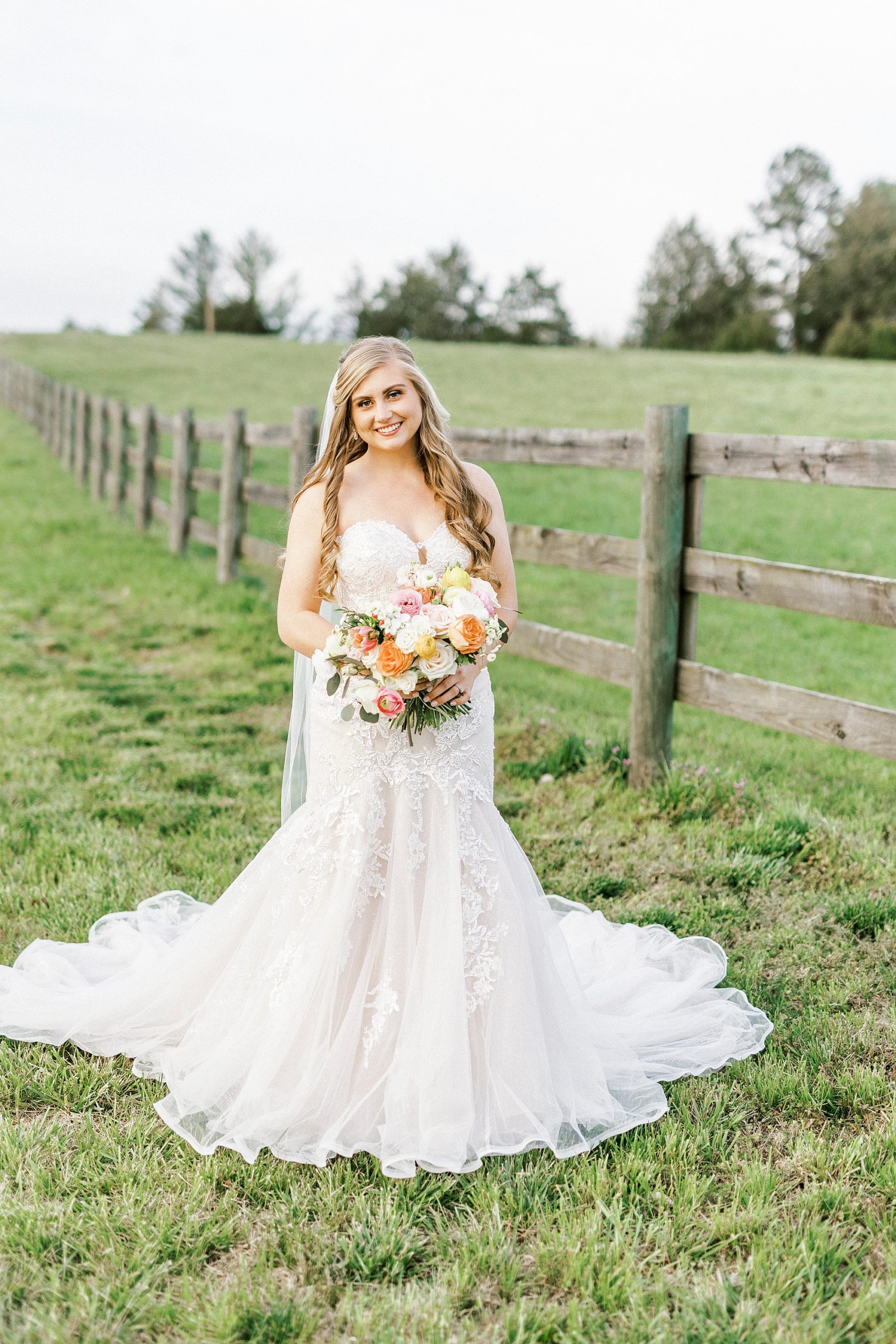 bride holds bouquet of colorful flowers