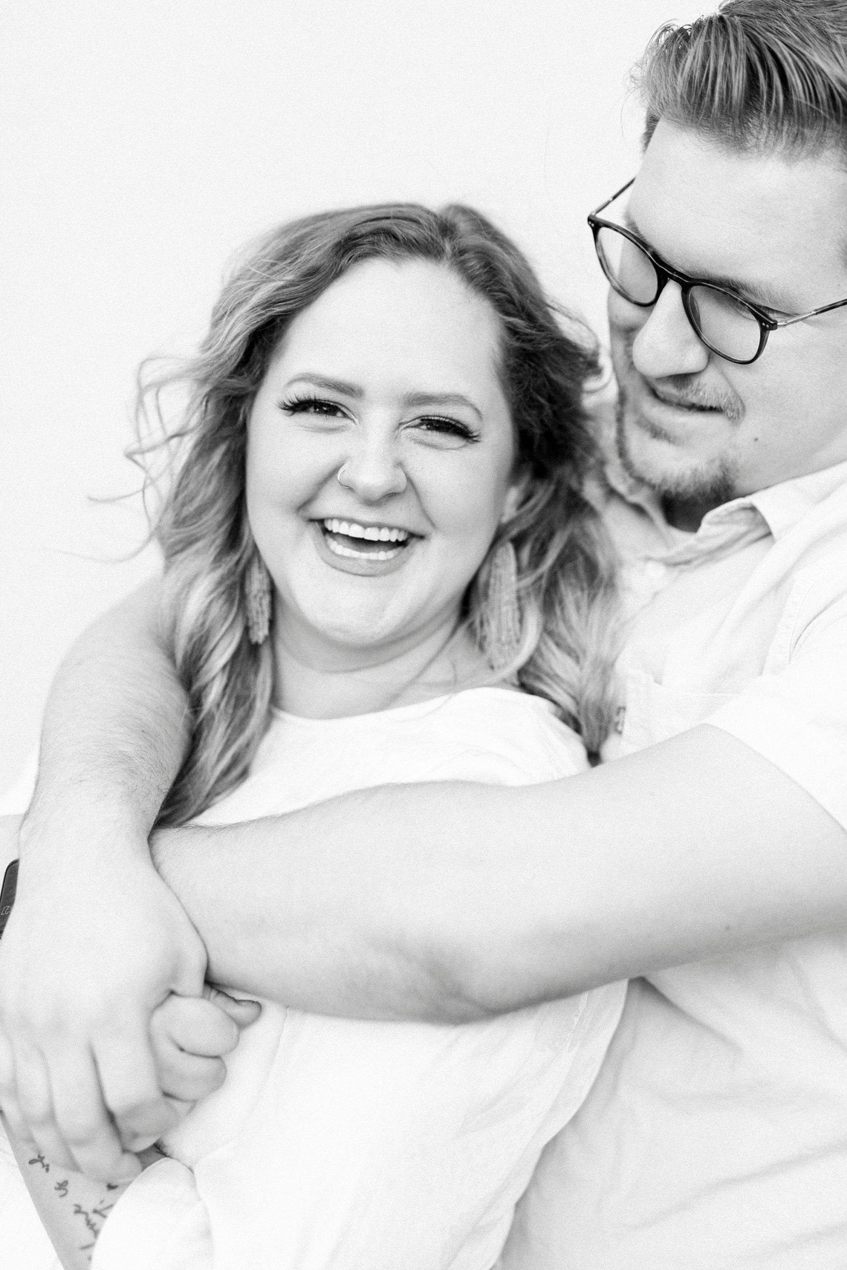 husband hugs wife during Downtown Charleston Anniversary Portraits