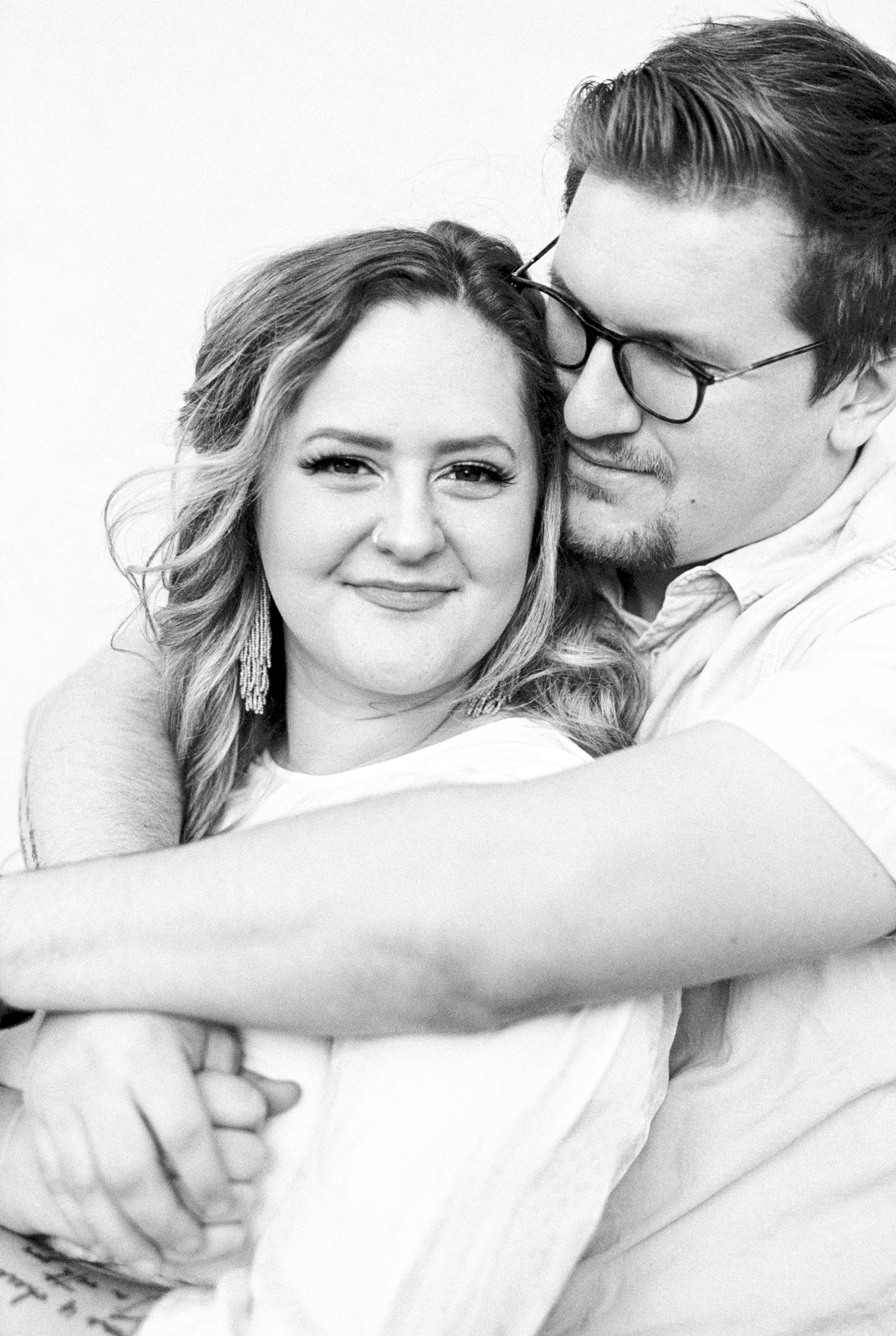 groom hugs wife during downtown Charleston anniversary portraits