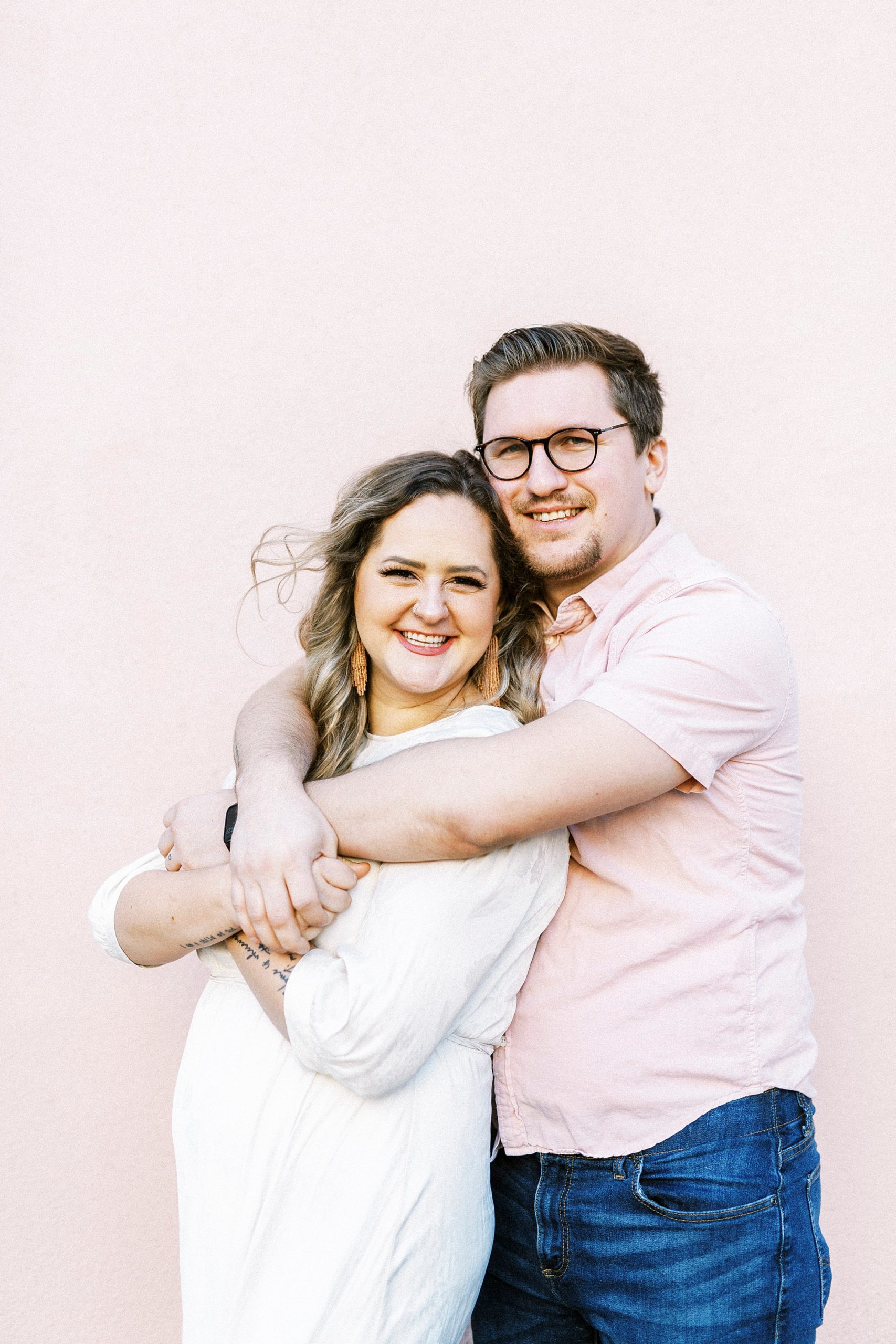 man hugs wife during downtown Charleston anniversary portraits