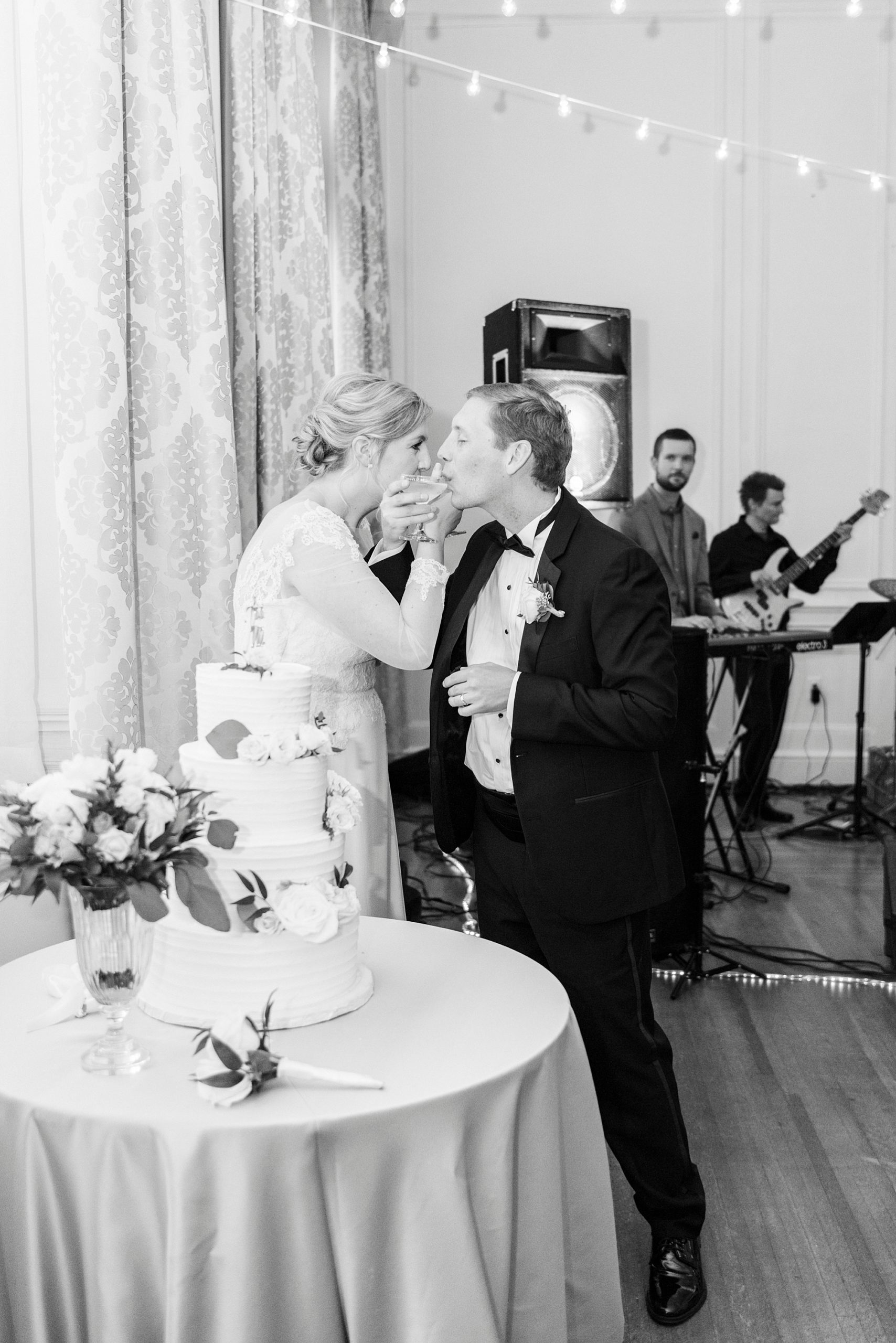 bride and groom drink champagne with linked arms 