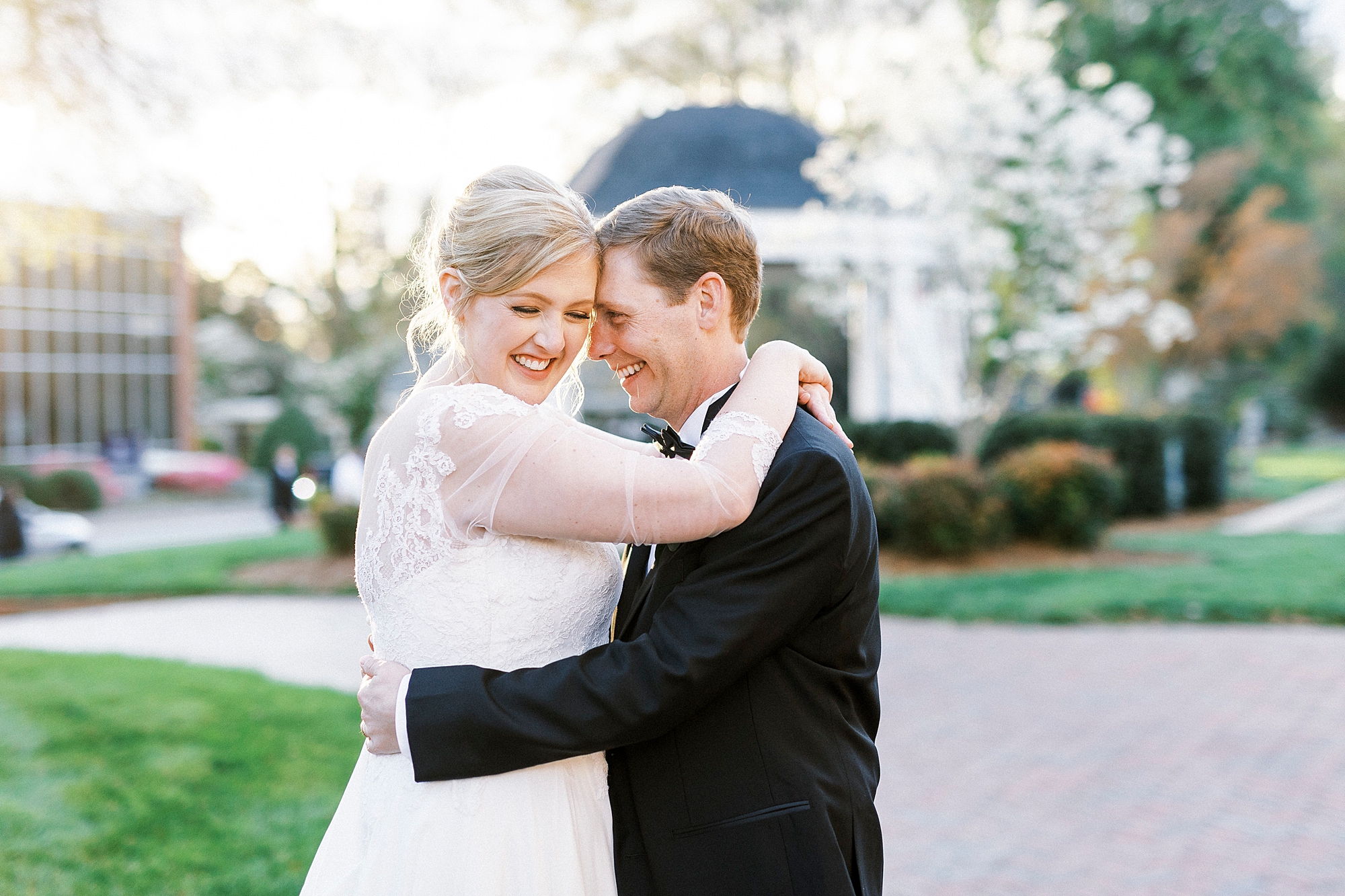 bride and groom laugh together during NC wedding photos