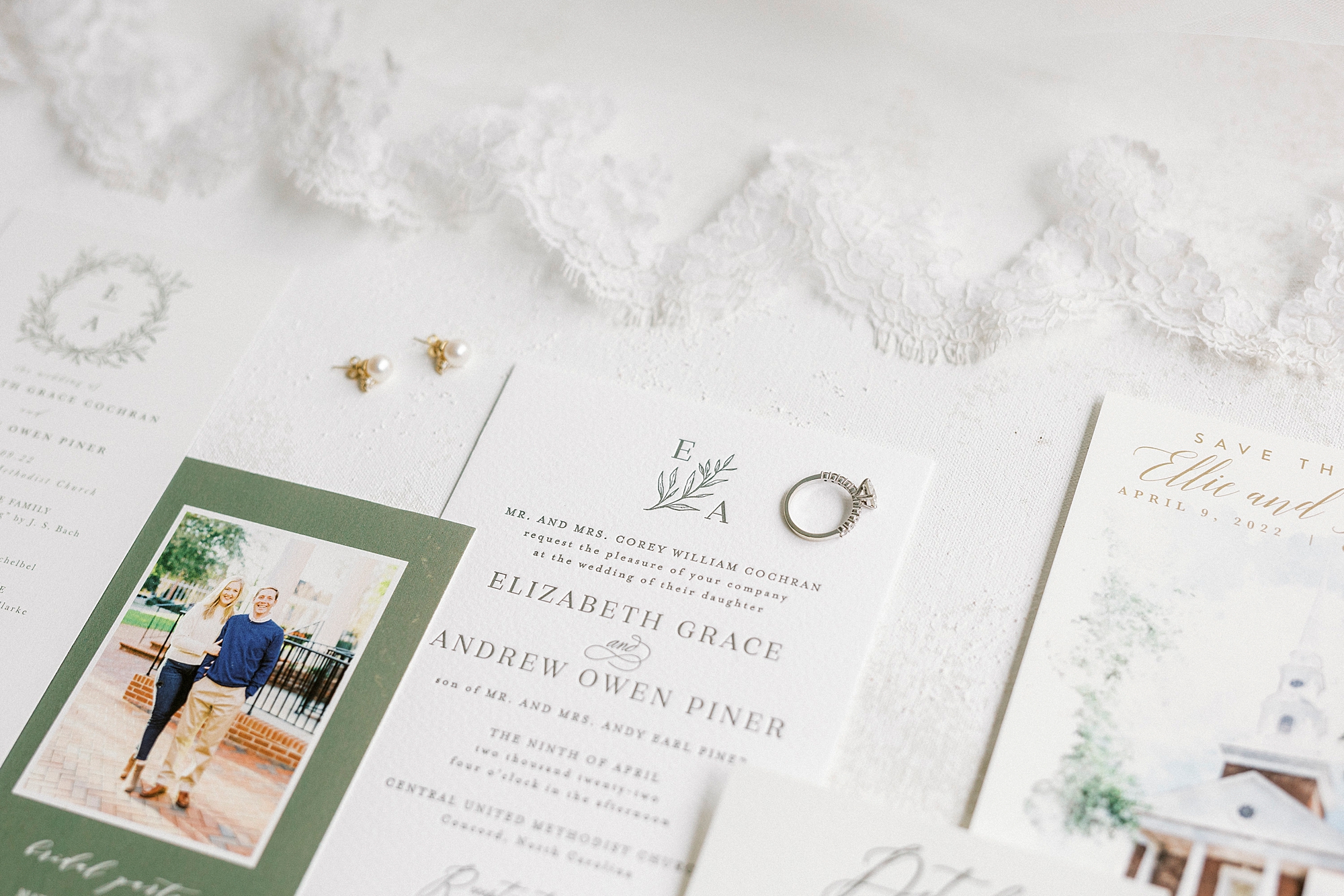 wedding ring rests on invitations for Hotel Concord wedding