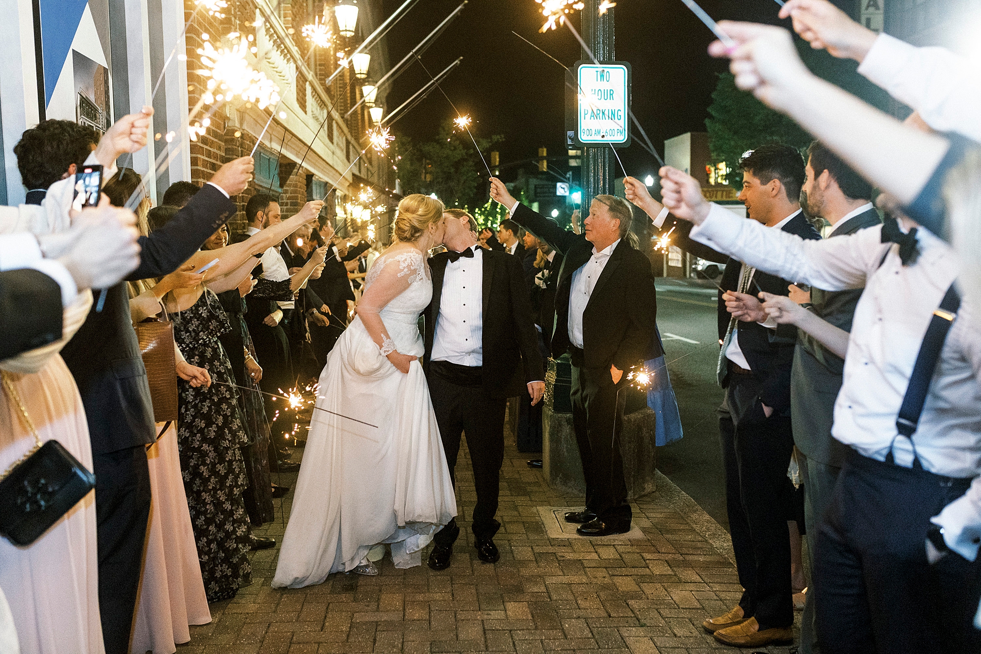 couple kisses during sparkler exit