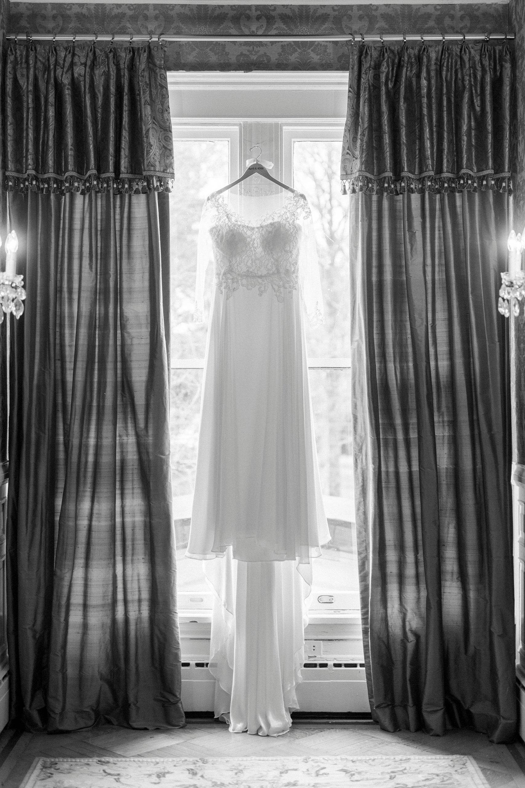 wedding dress hangs in window of NC hotel 