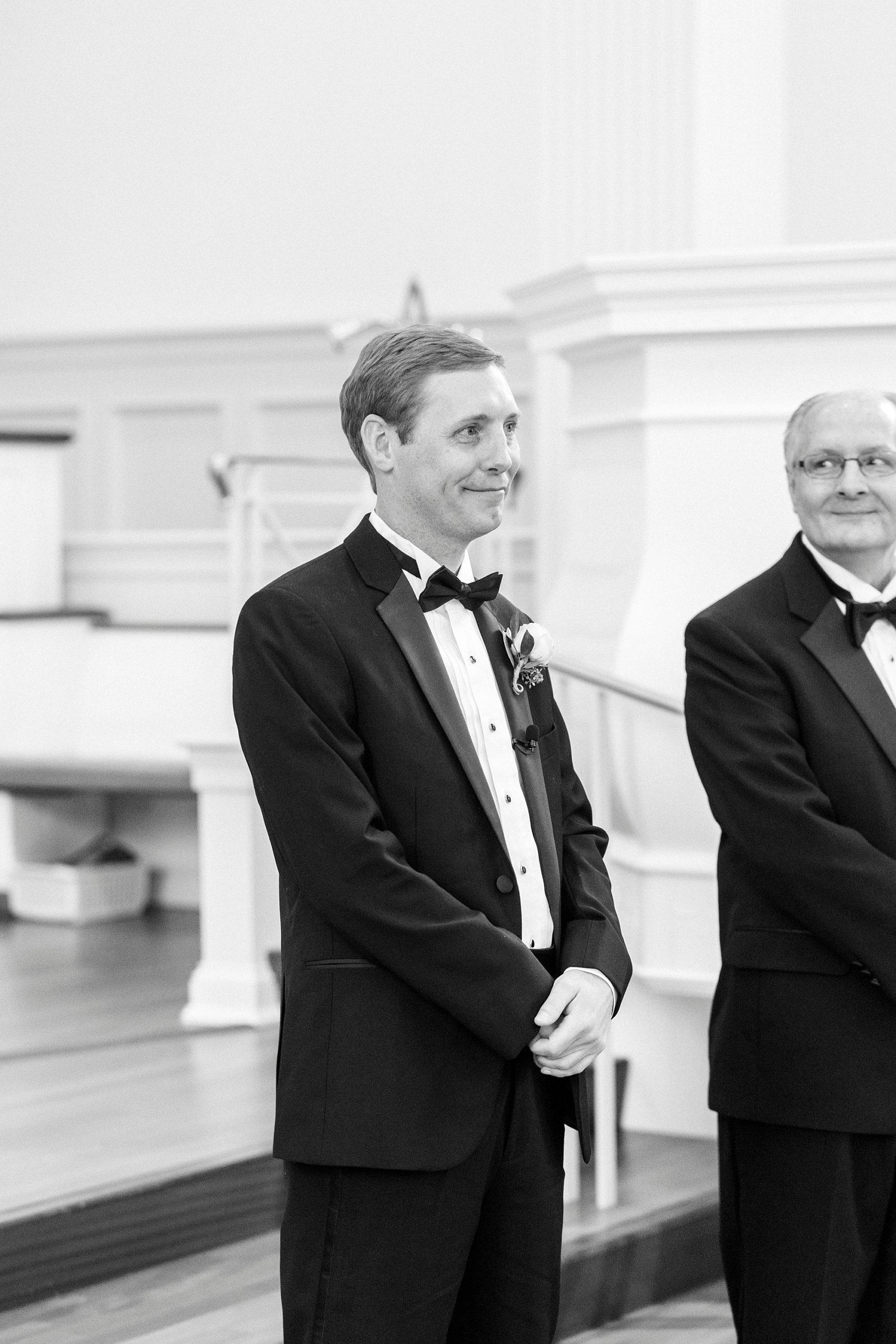 groom tears up watching bride walk down aisle during traditional church wedding in Concord NC