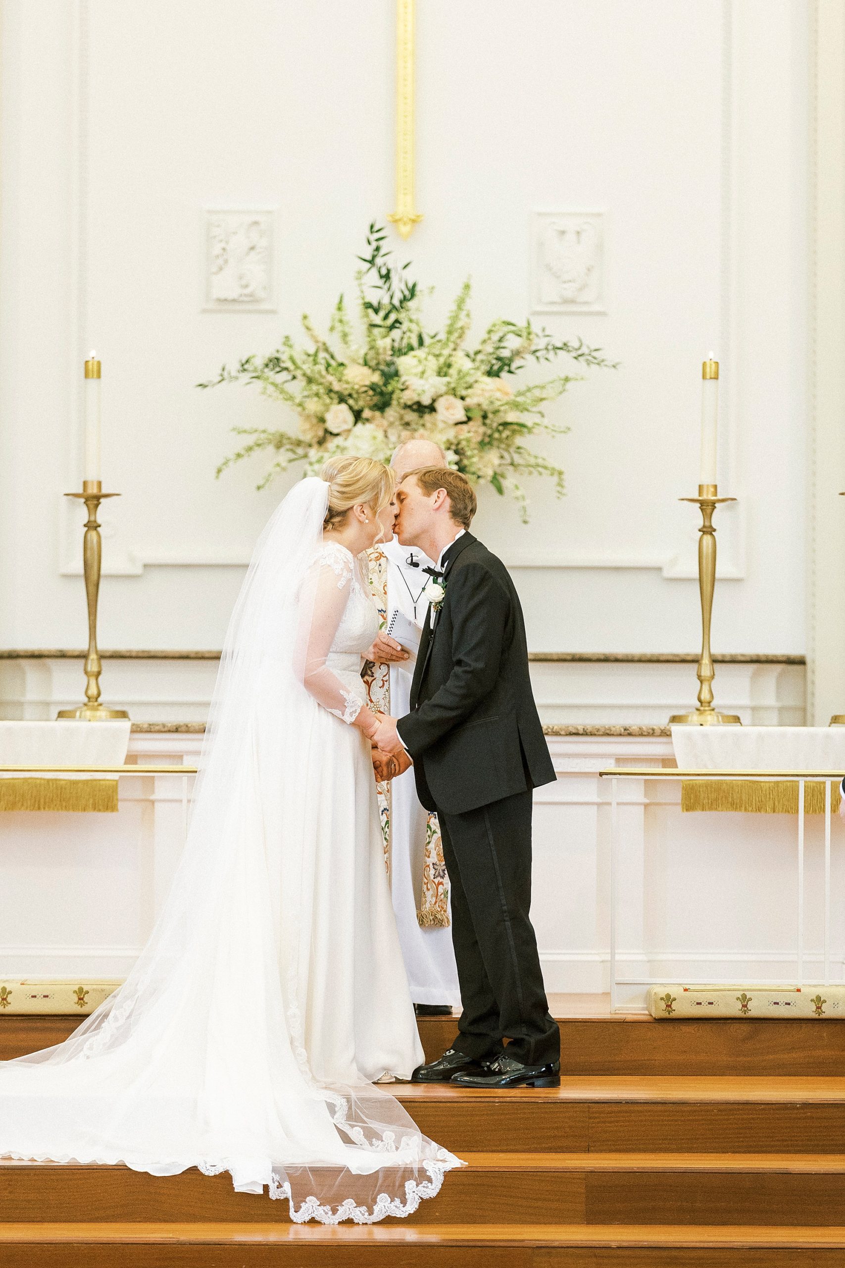 bride and groom kiss during traditional church wedding in Concord NC