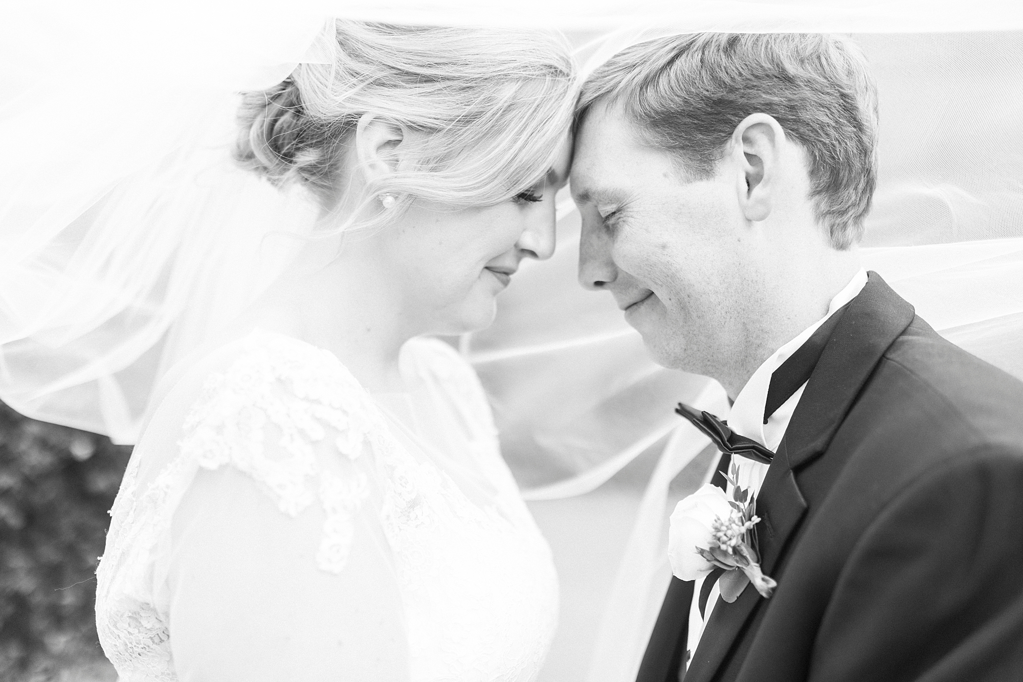 bride and groom lean foreheads together 
