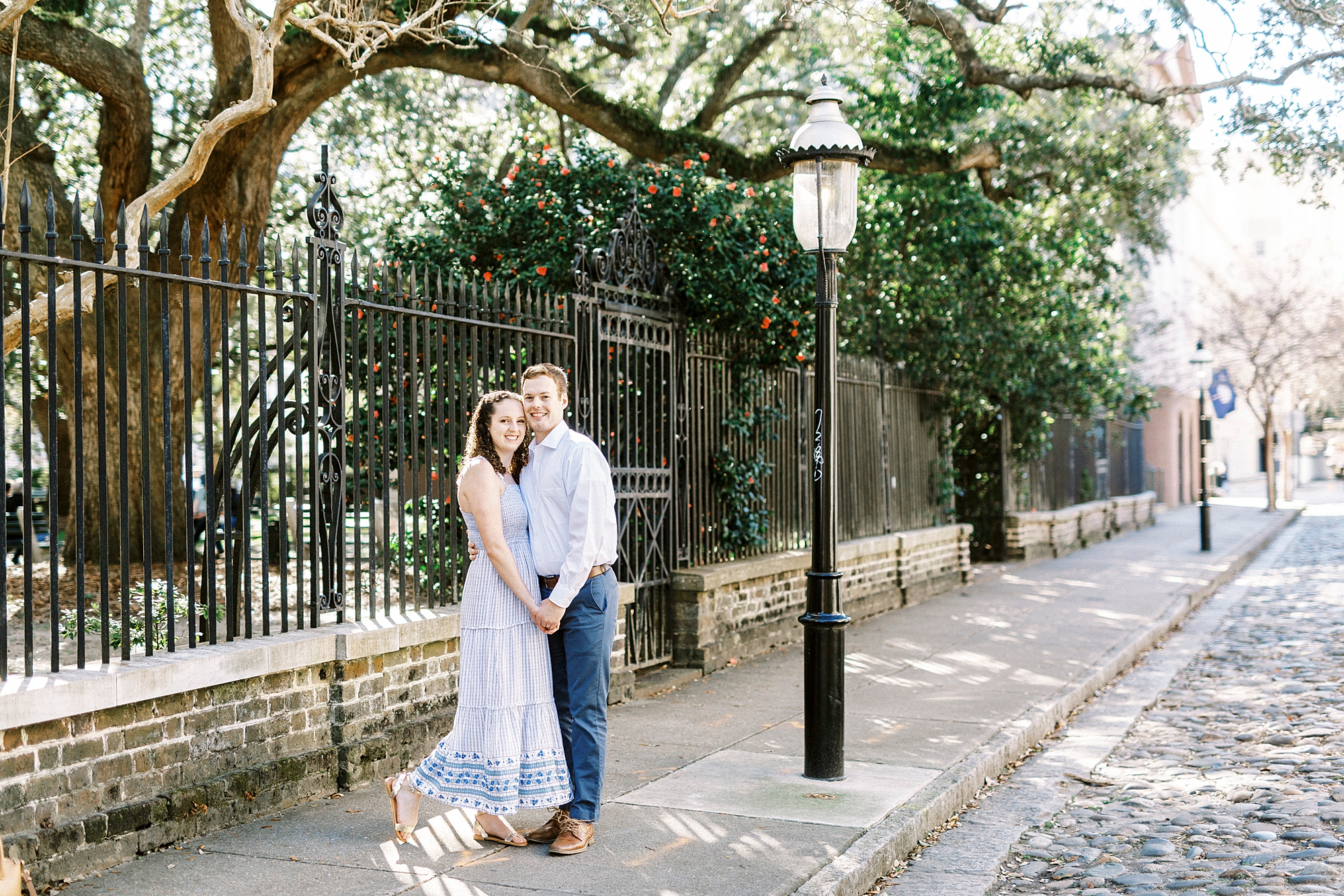 couple stands by lamppost during Washington Park anniversary portraits