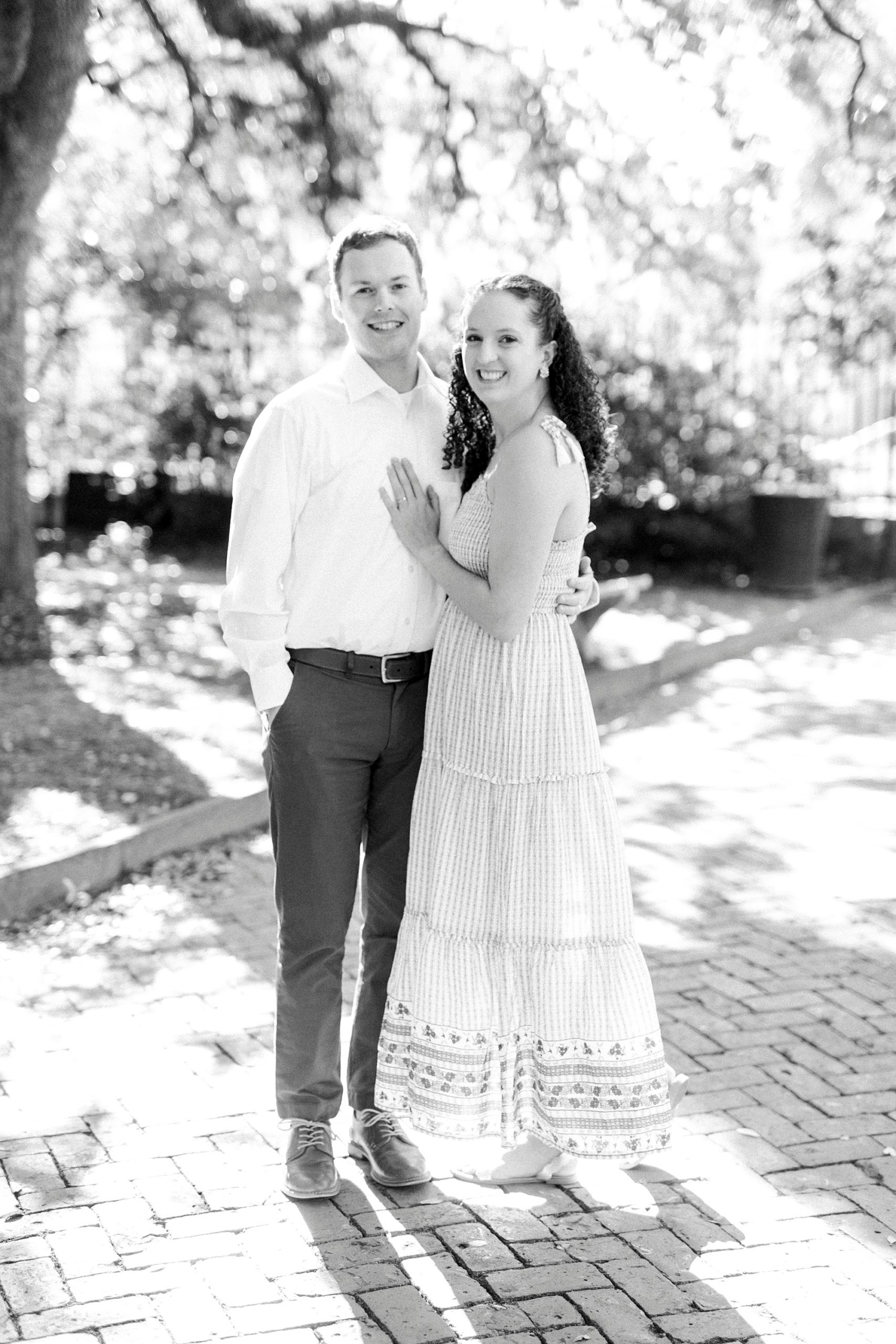 husband and wife pose together in Charleston park