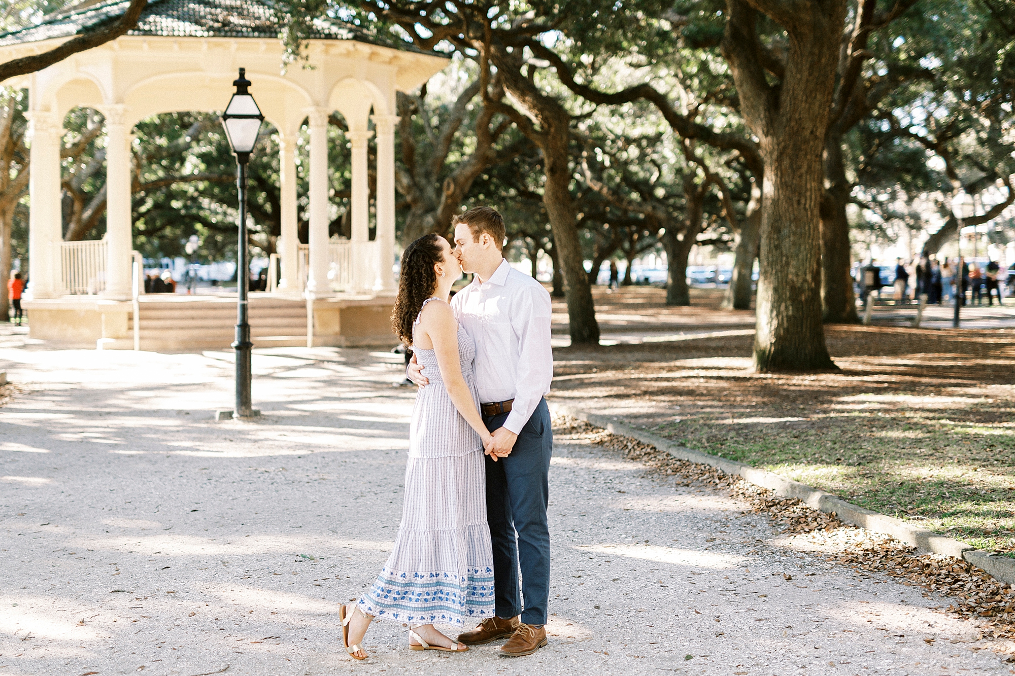 husband and wife pose outside gazebo in Washington Park