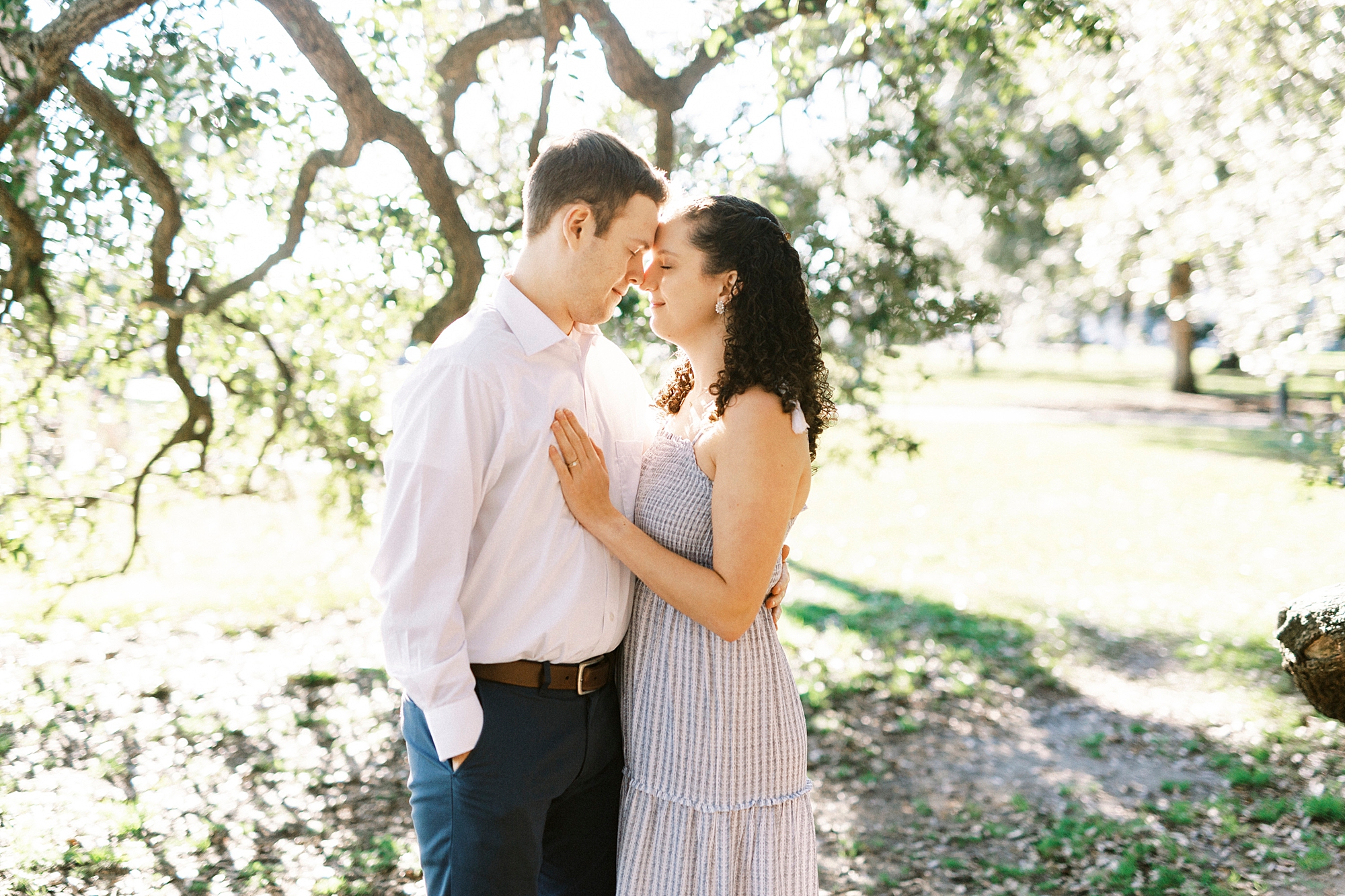 husband and wife stand together during Washington Park anniversary portraits 