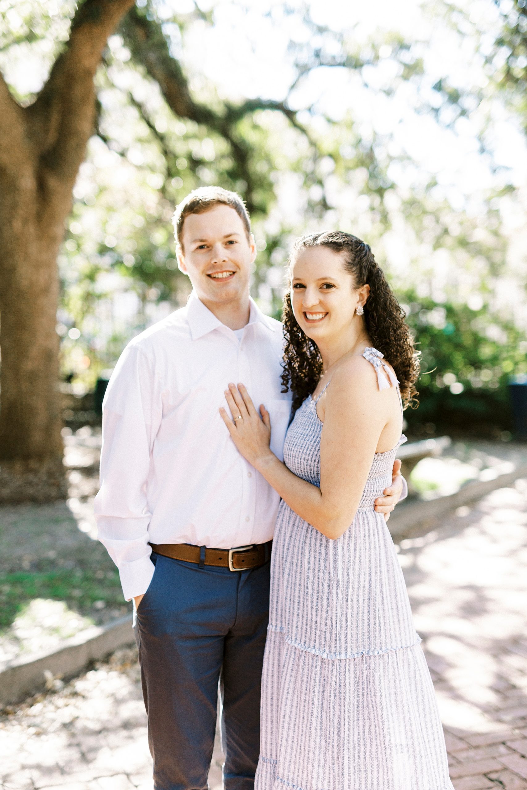 woman leans against groom's chest during Washington Park anniversary portraits