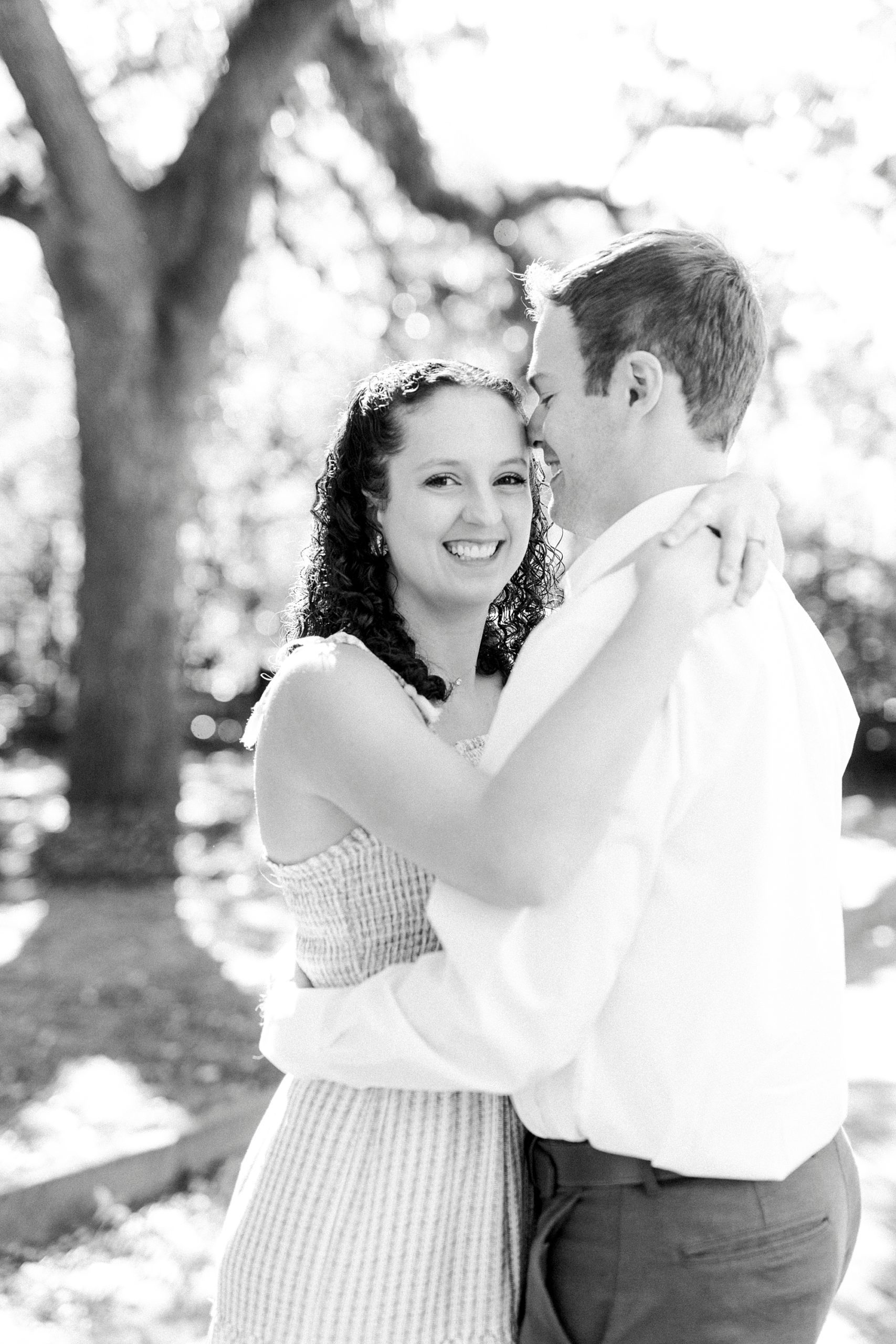 husband hugs wife during anniversary photos in Washington Park