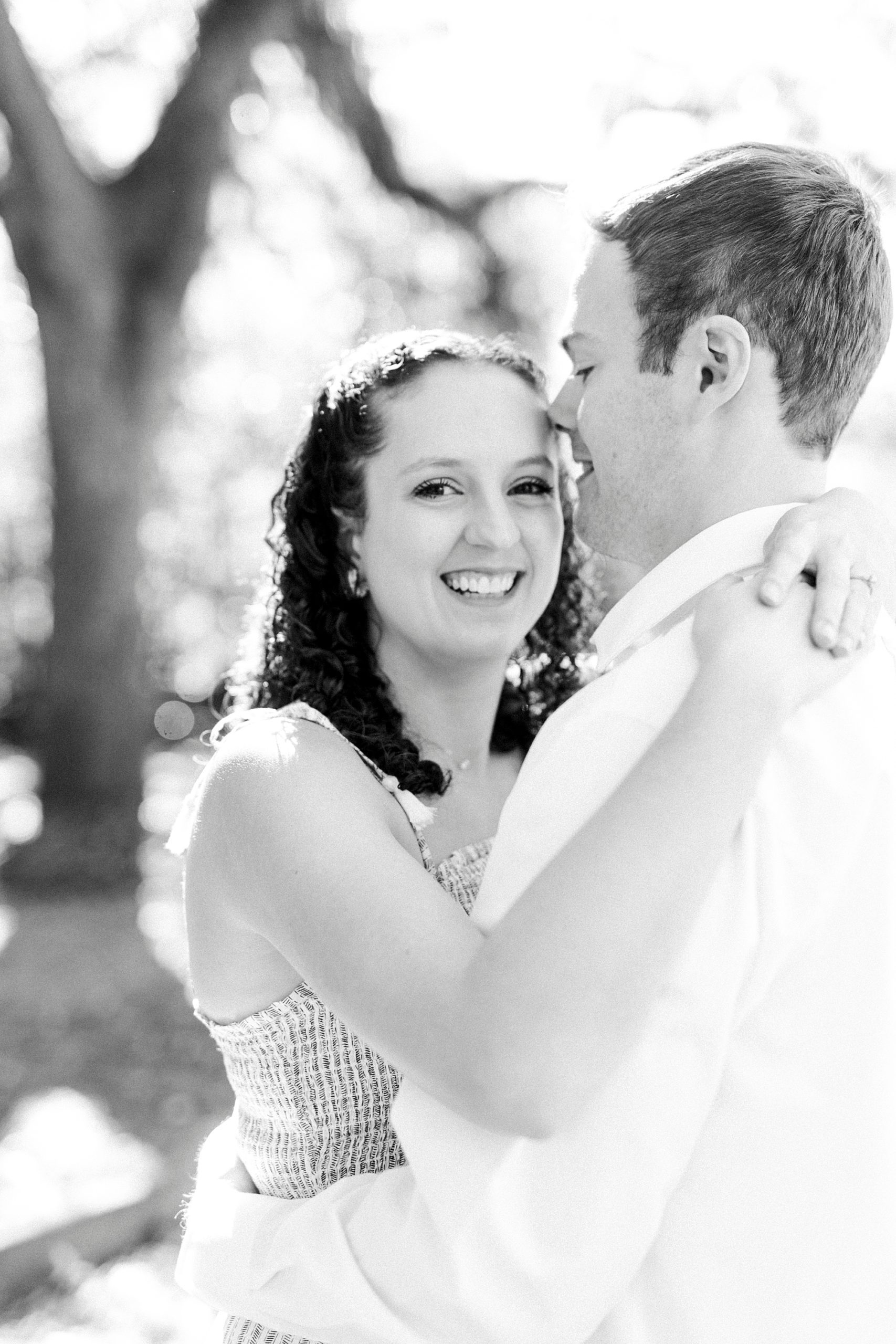 man kisses wife's forehead during Washington Park anniversary portraits 