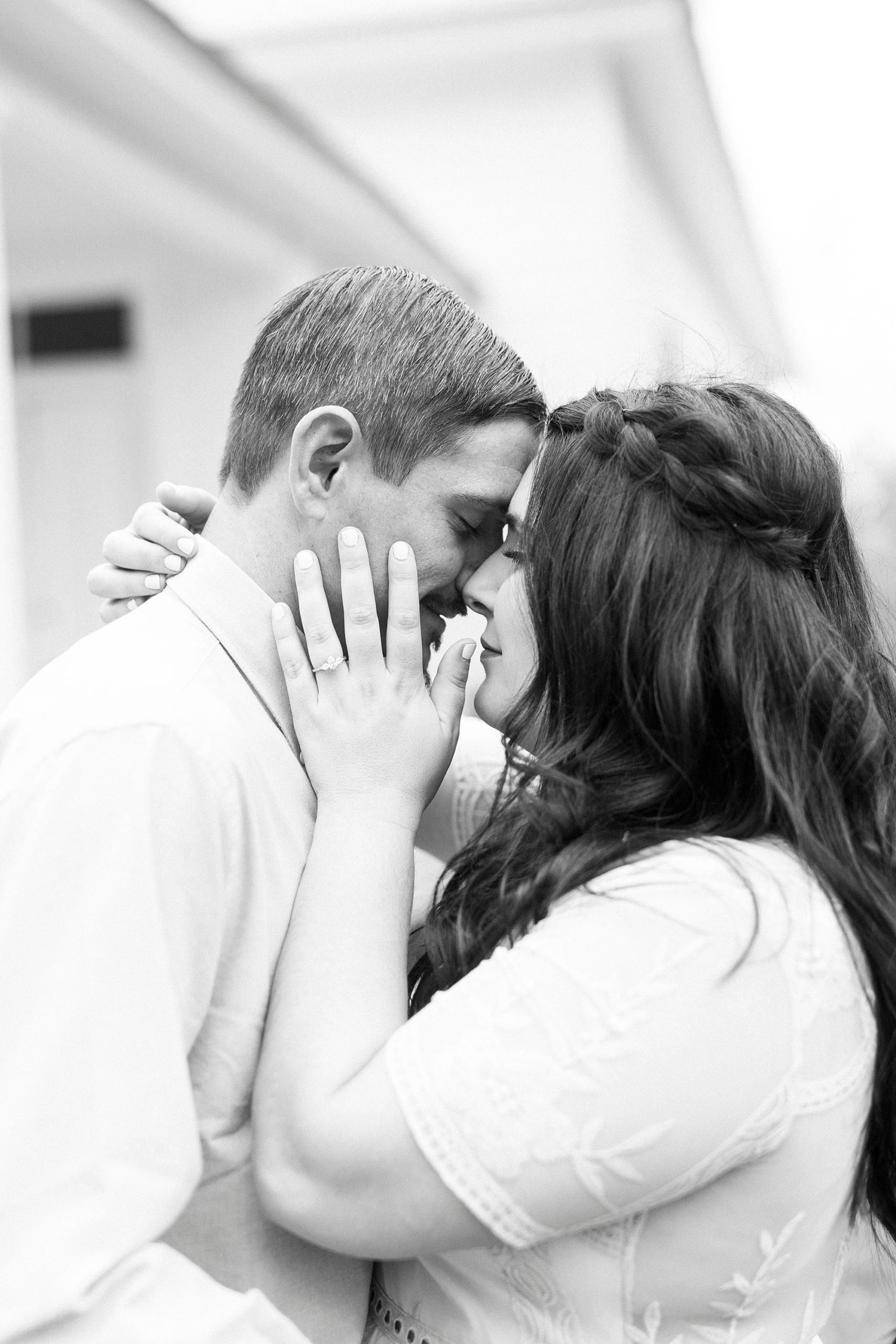 bride and groom lean foreheads together touching noses