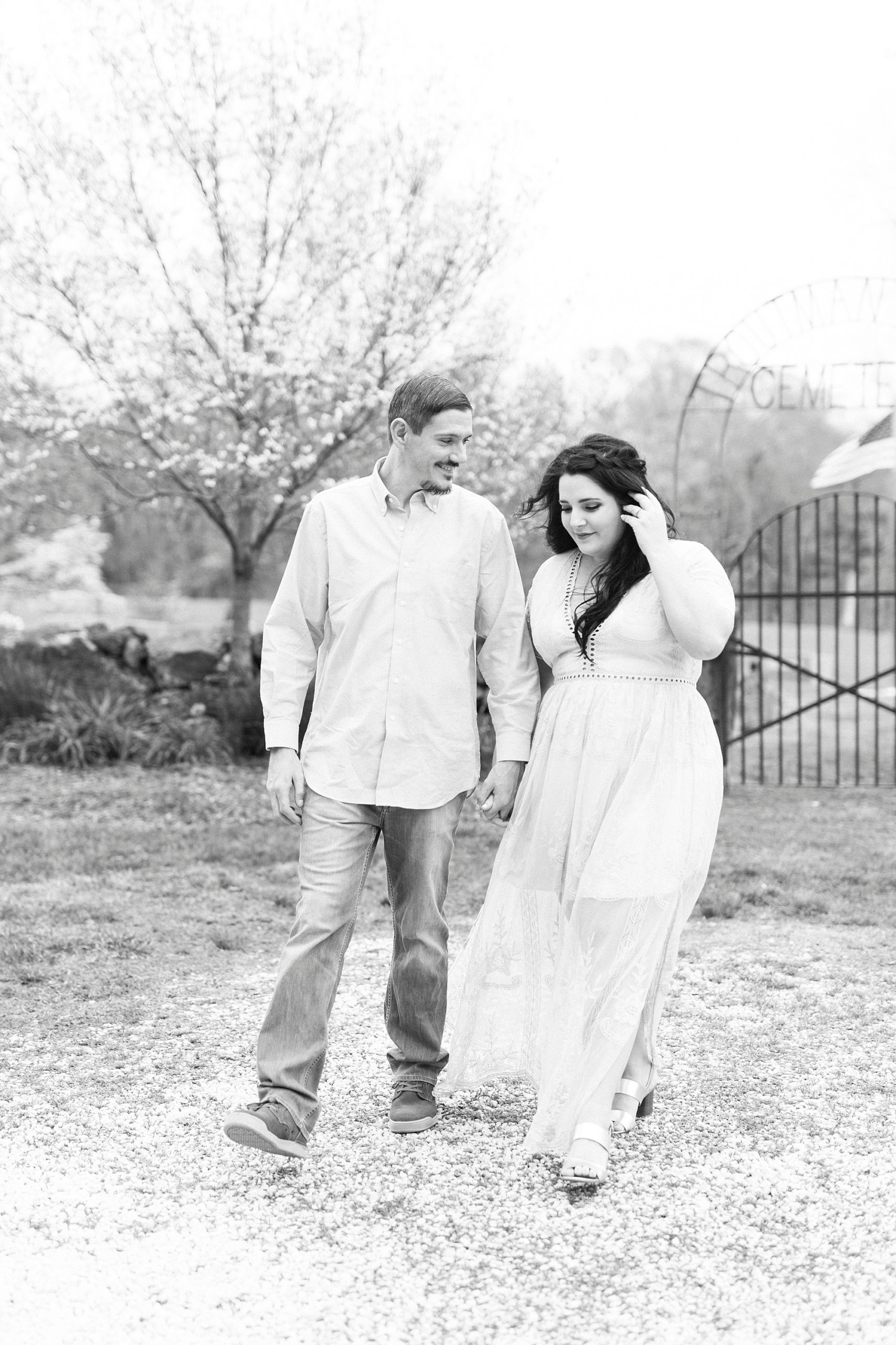 bride and groom hold hands while wind blows bride's dress