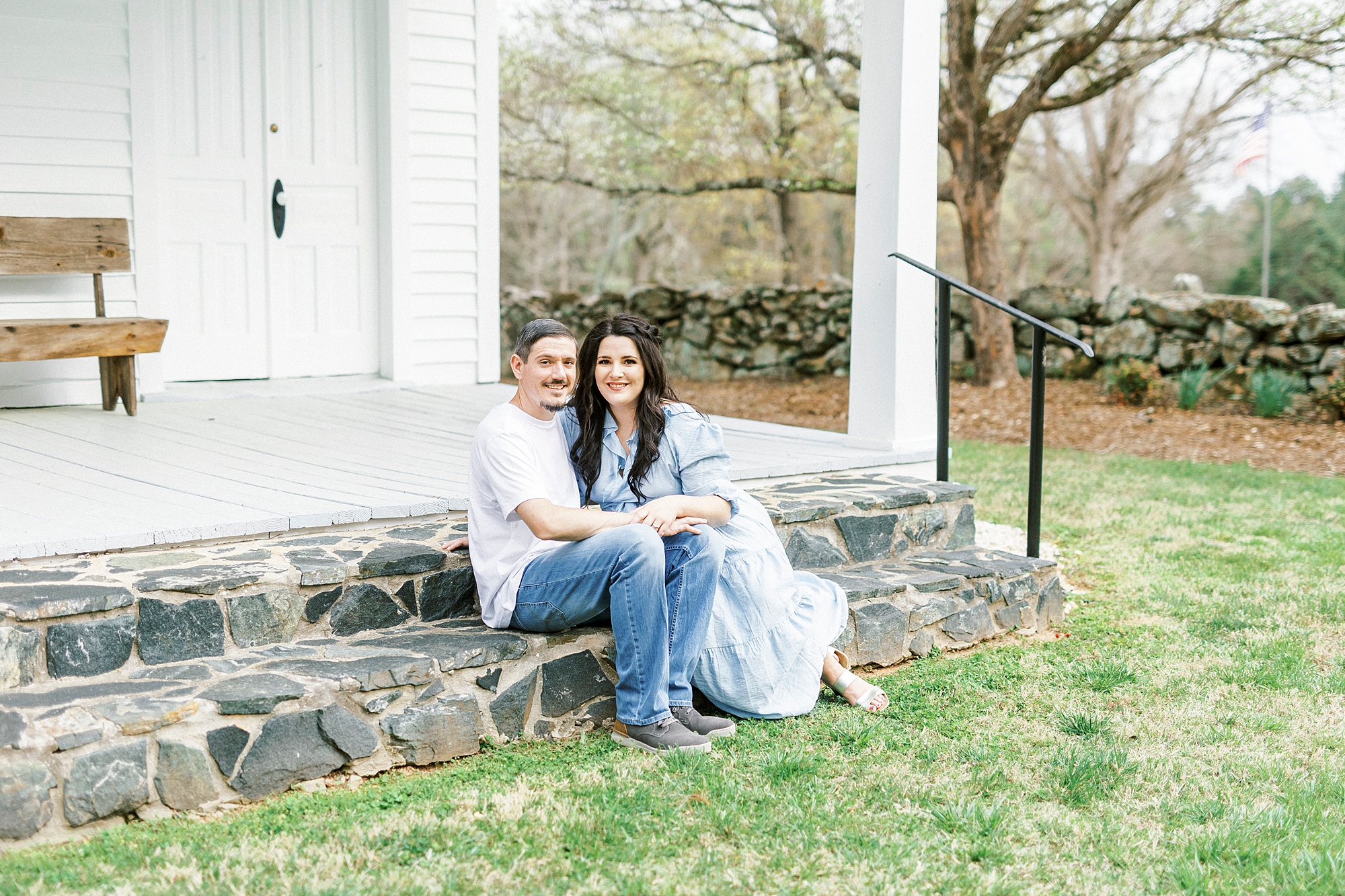 bride and groom sit on steps of family chapel