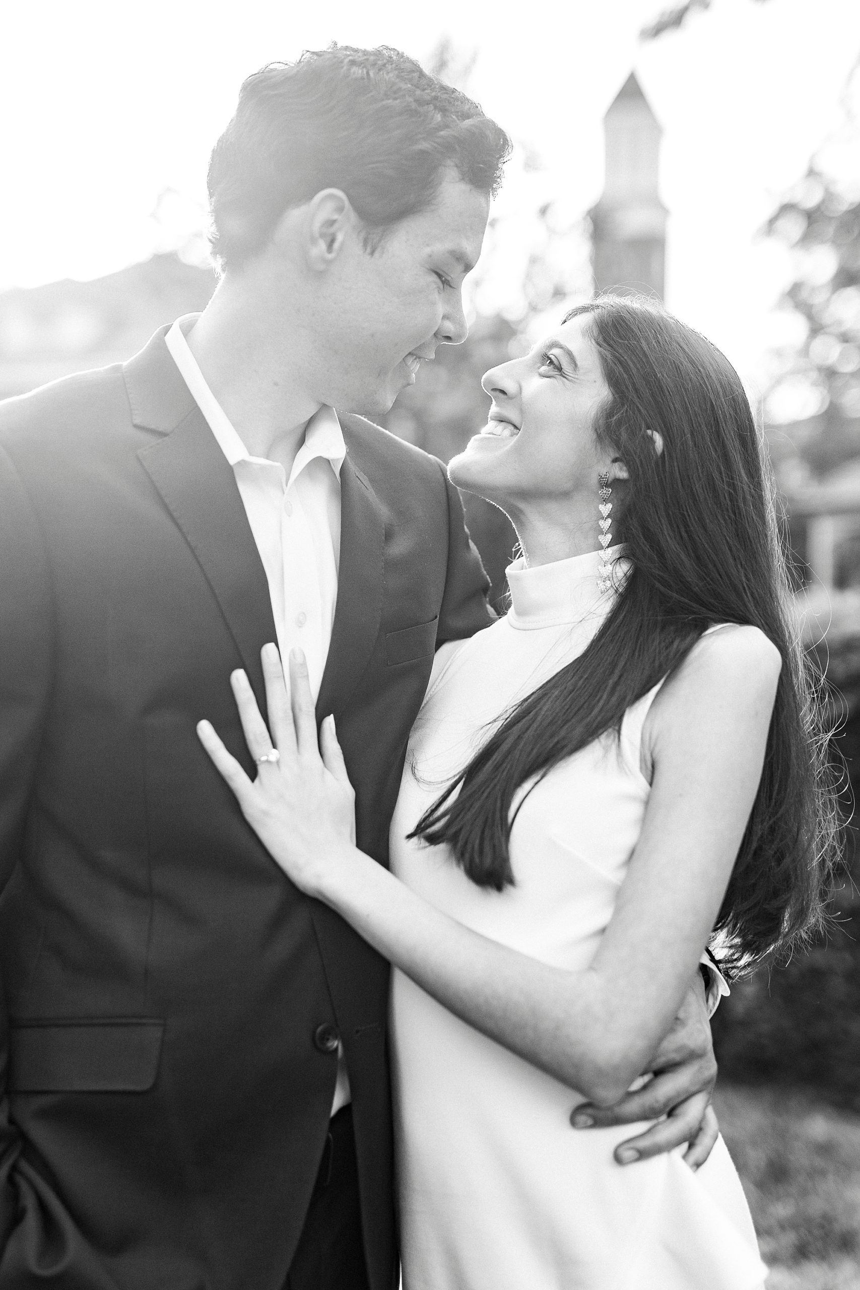 engaged couple hugs in gardens at Queens University