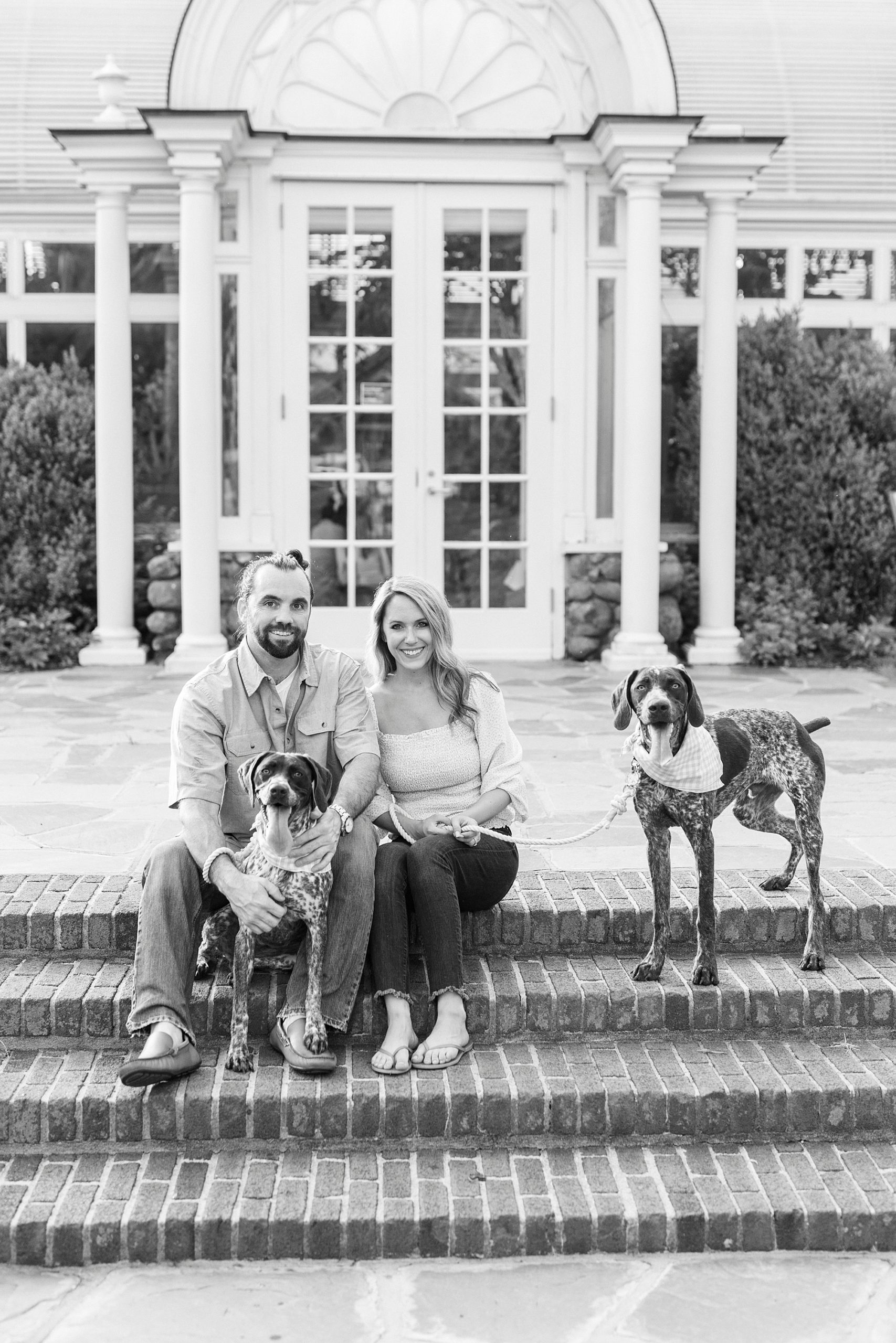 couple sits on steps of Reynolda Gardens entryway