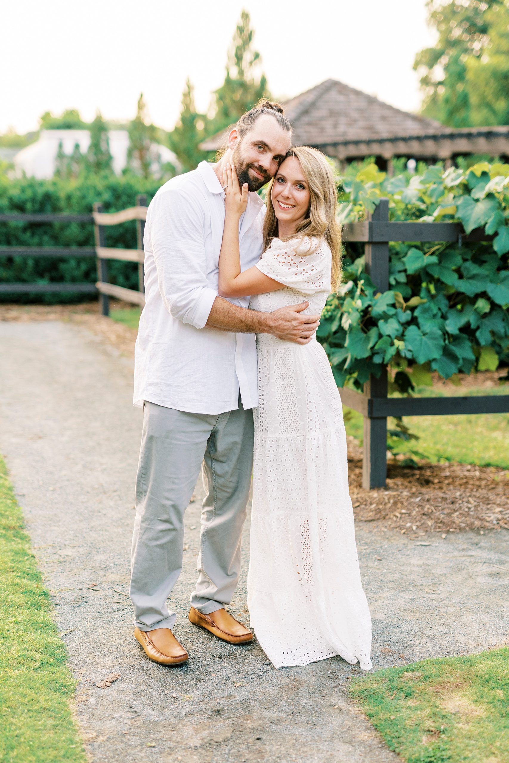 bride and groom hug during Reynolda Gardens engagement session
