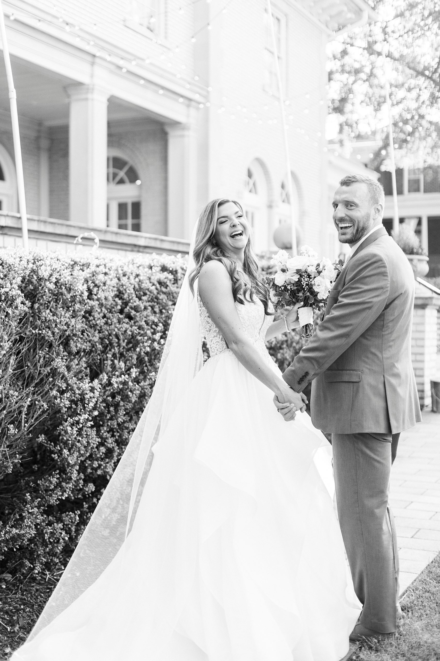 couple laughs holding hands walking through Separk Mansion