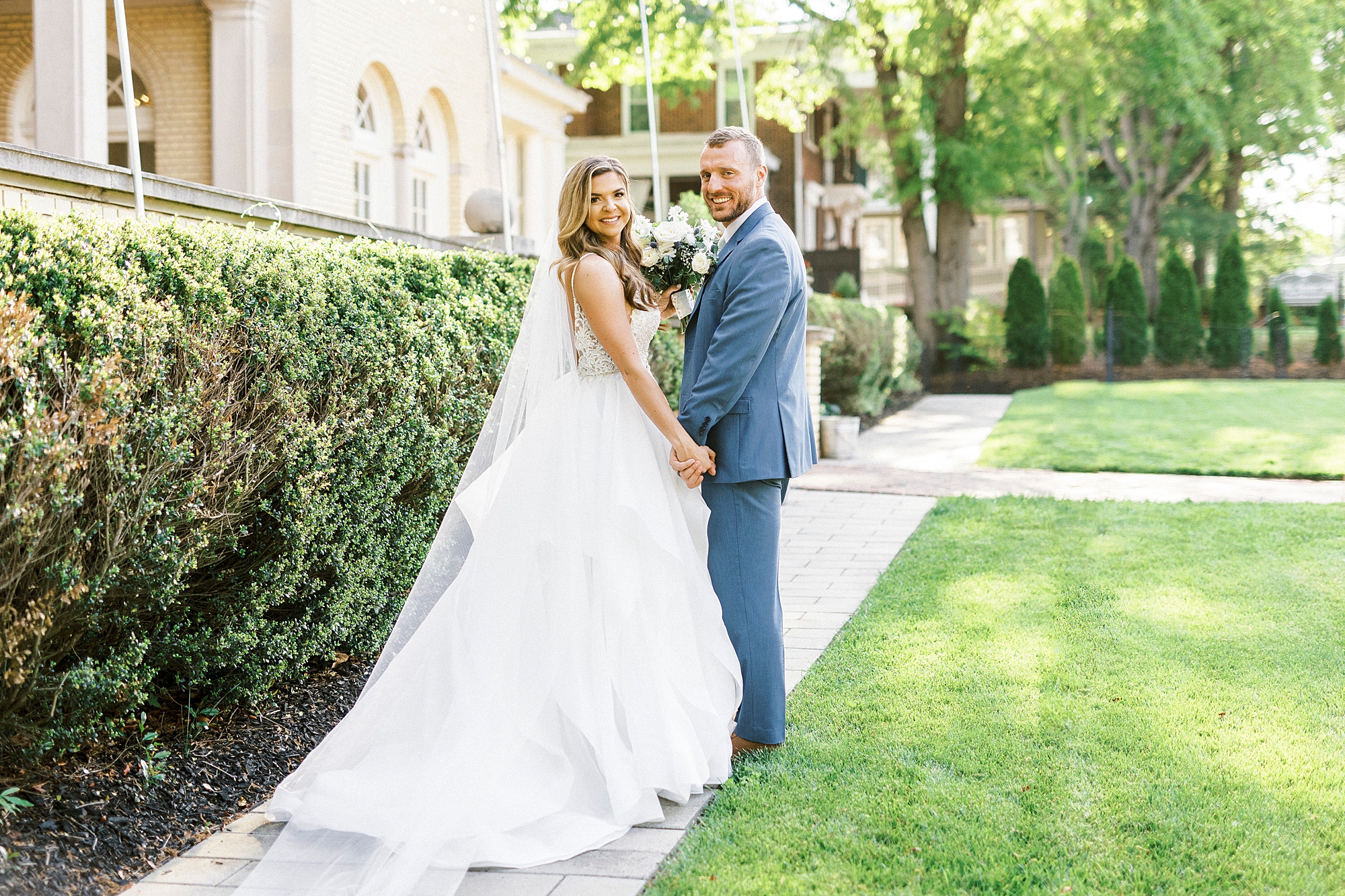 newlyweds stand on pathway at Separk Mansion