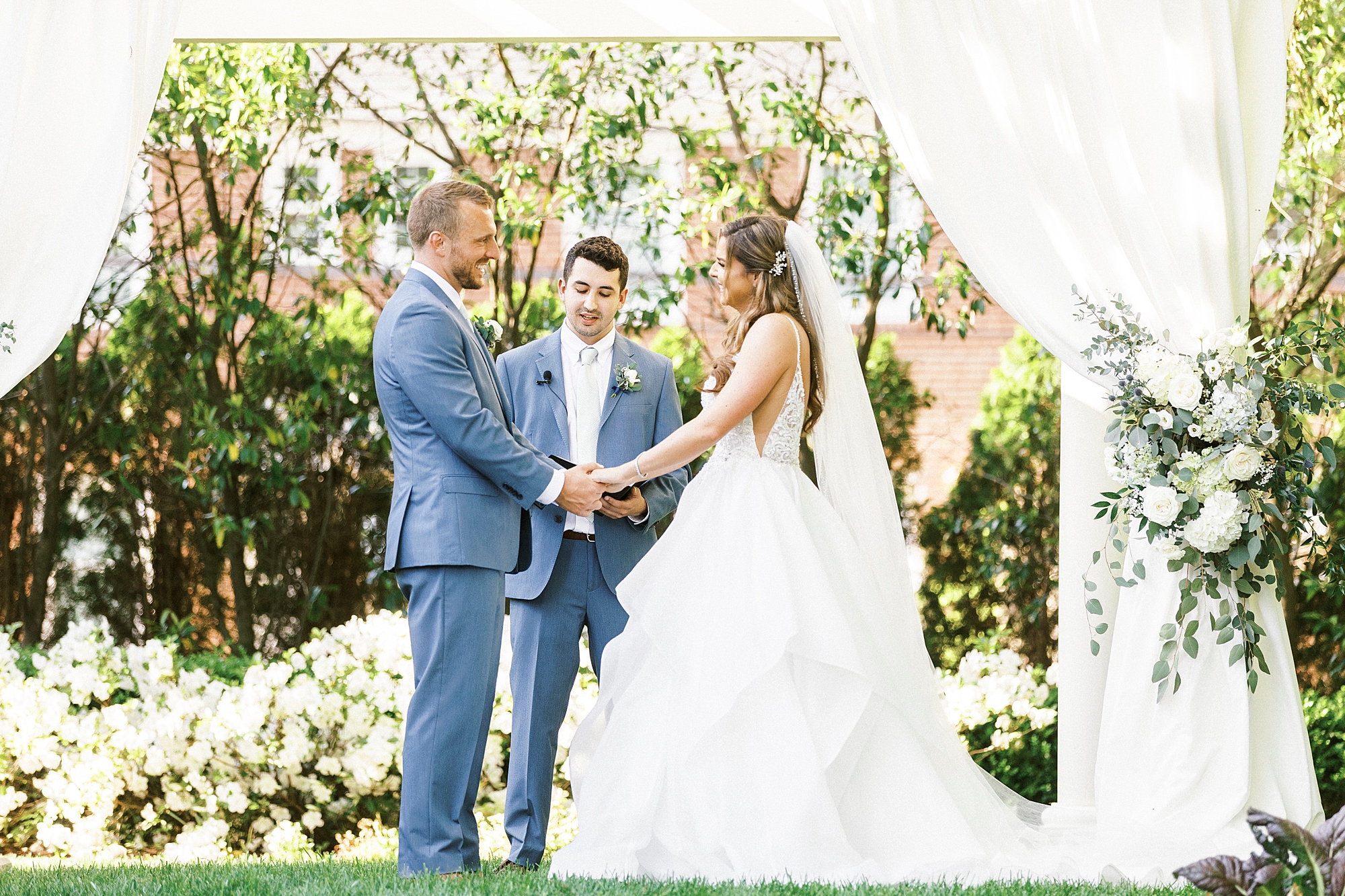 bride and groom exchange vows during ceremony under canopy at Separk Mansion