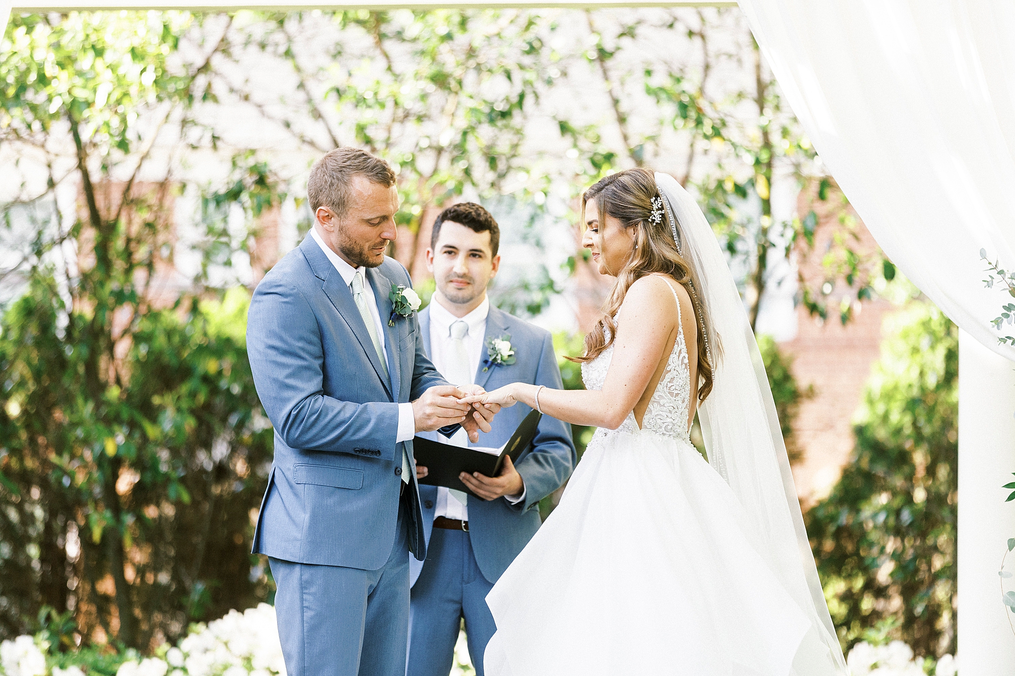 bride and groom exchange vows during ceremony under canopy at Separk Mansion
