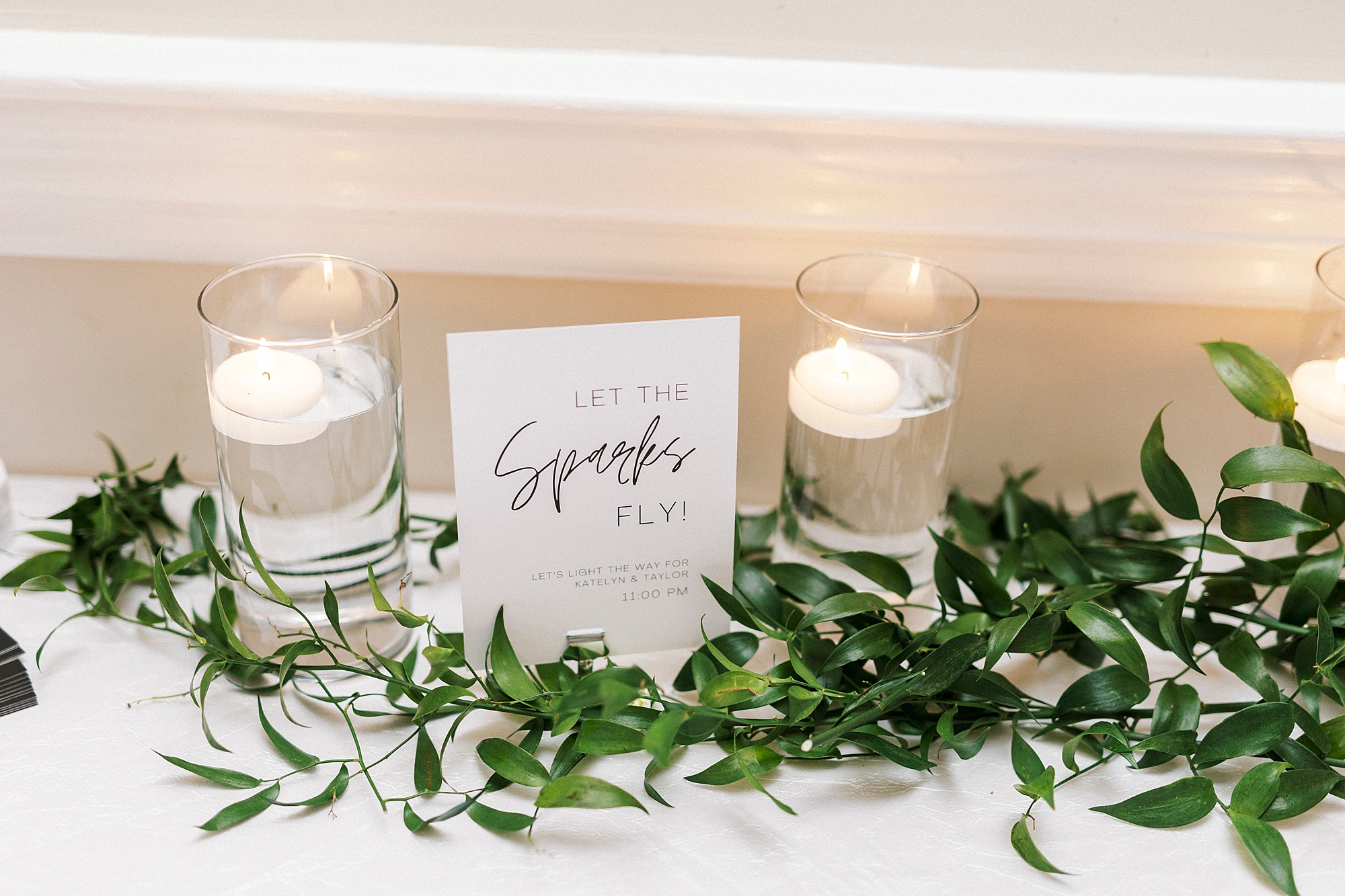 sign for wedding reception between two floating candles