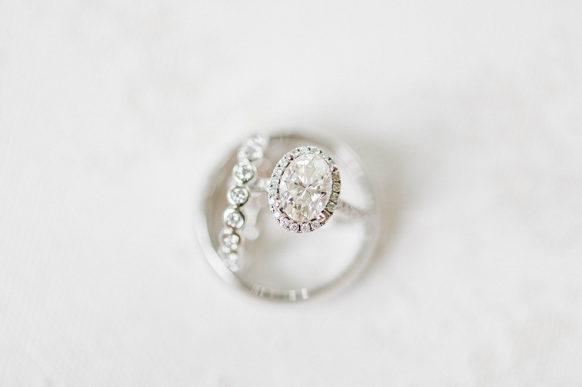 wedding bands rest together on white marble