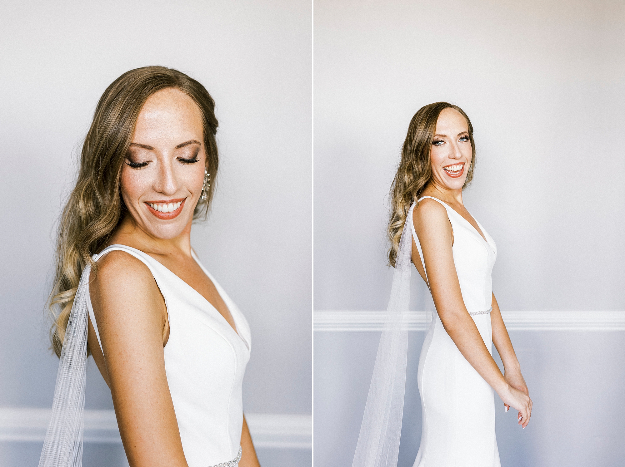 bride poses in front of white wall at Separk Mansion showing off wedding gown wings