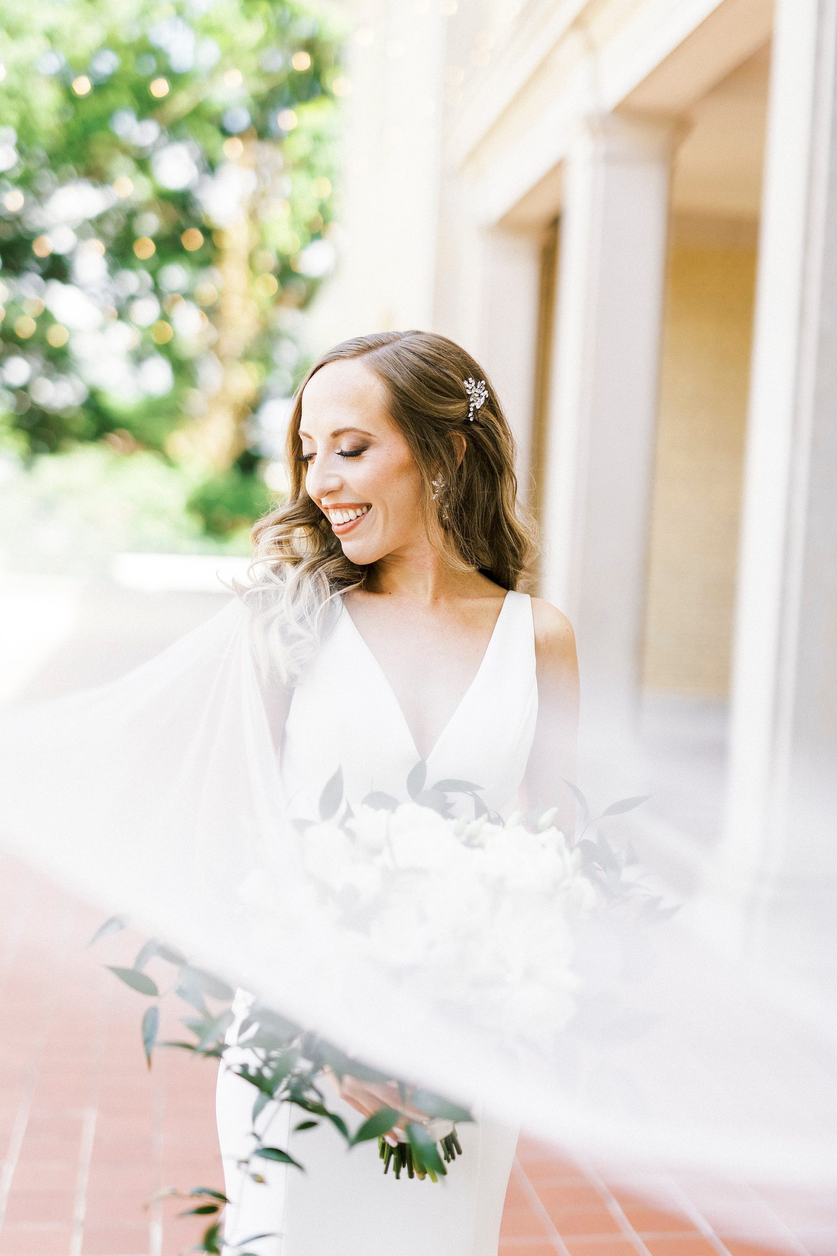 bride stands outside Separk Mansion with veil draped around her
