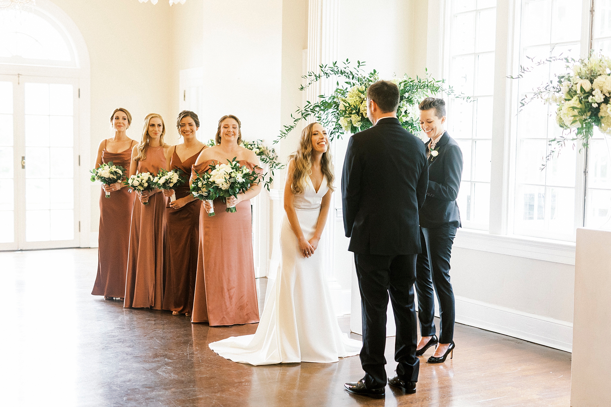 bride looks at groom during ceremony at Separk Mansion