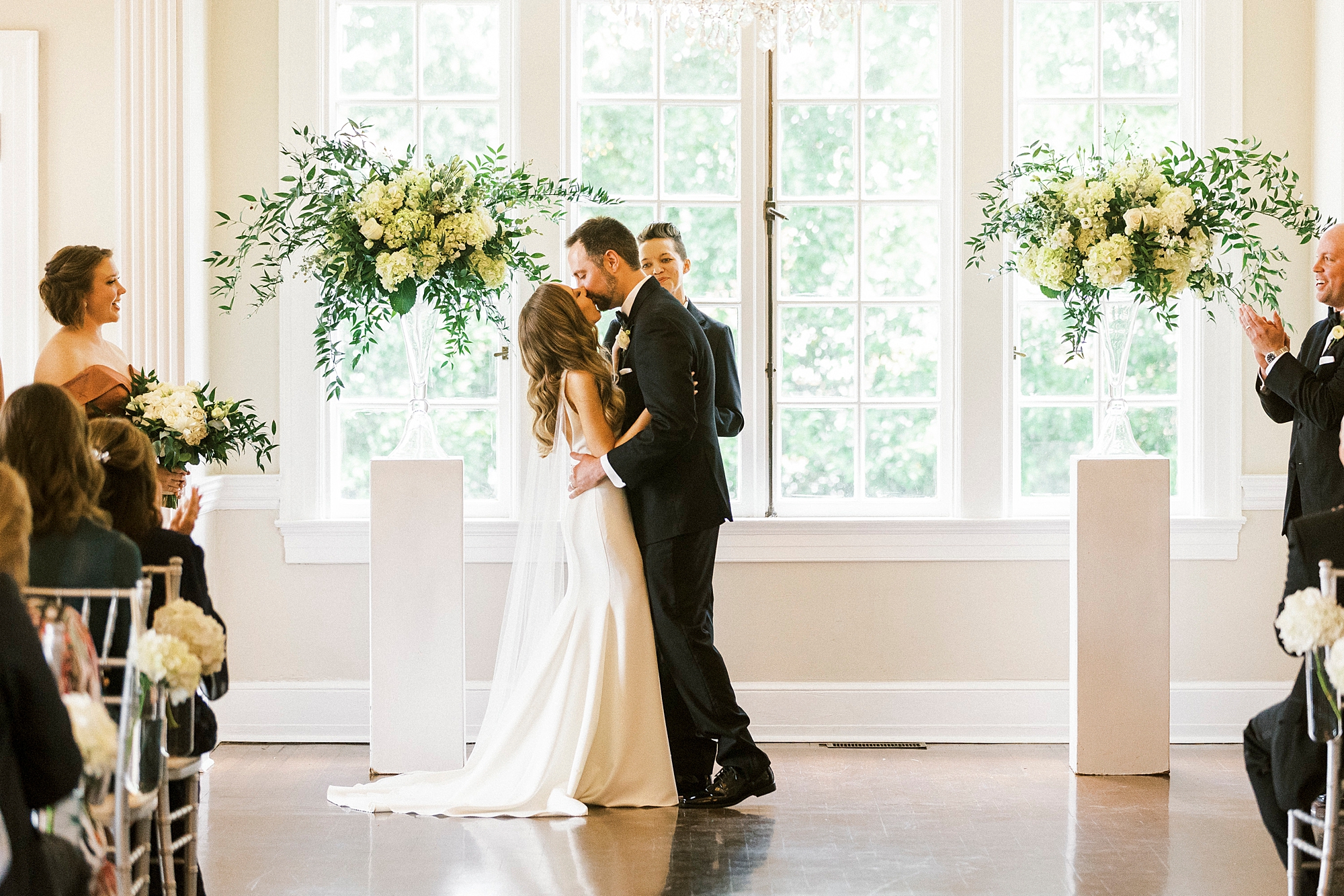 newlyweds kiss during wedding ceremony at Separk Mansion