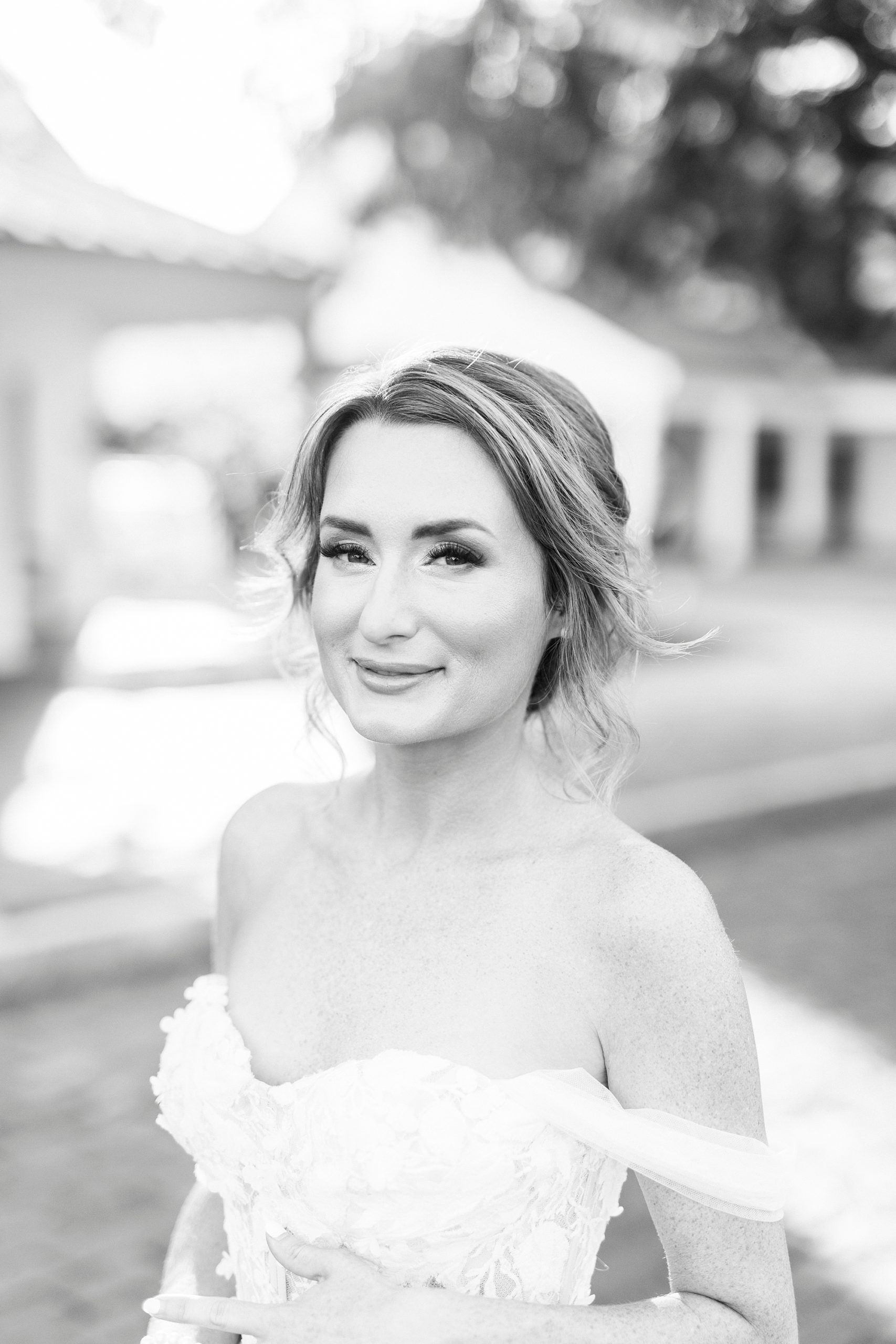 bride smiles in off-the-shoulder gown during Trump National Golf Club bridal portraits