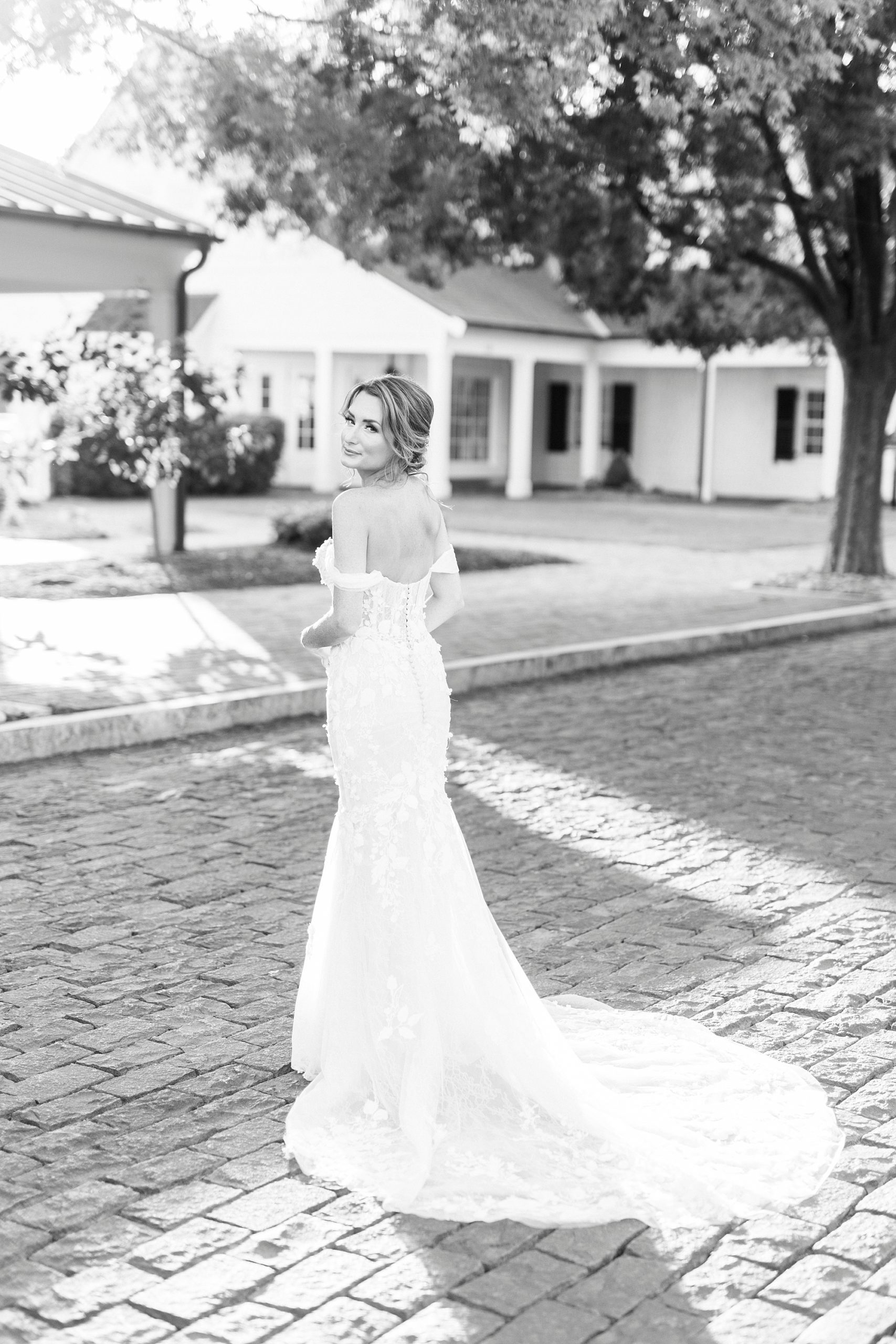 bride looks over shoulder during Trump National Golf Club bridal portraits