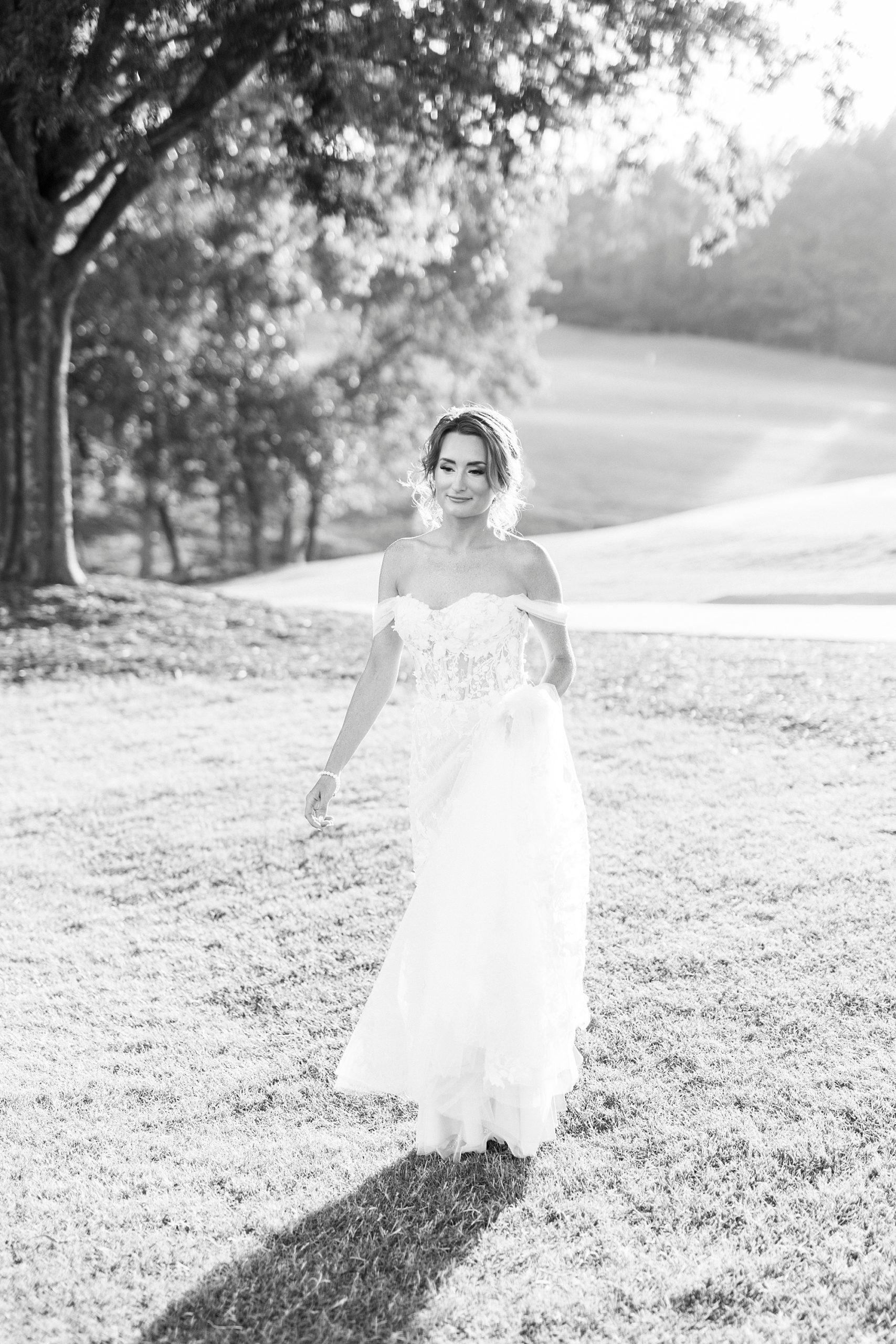 bride holds gown and turns on golf course 