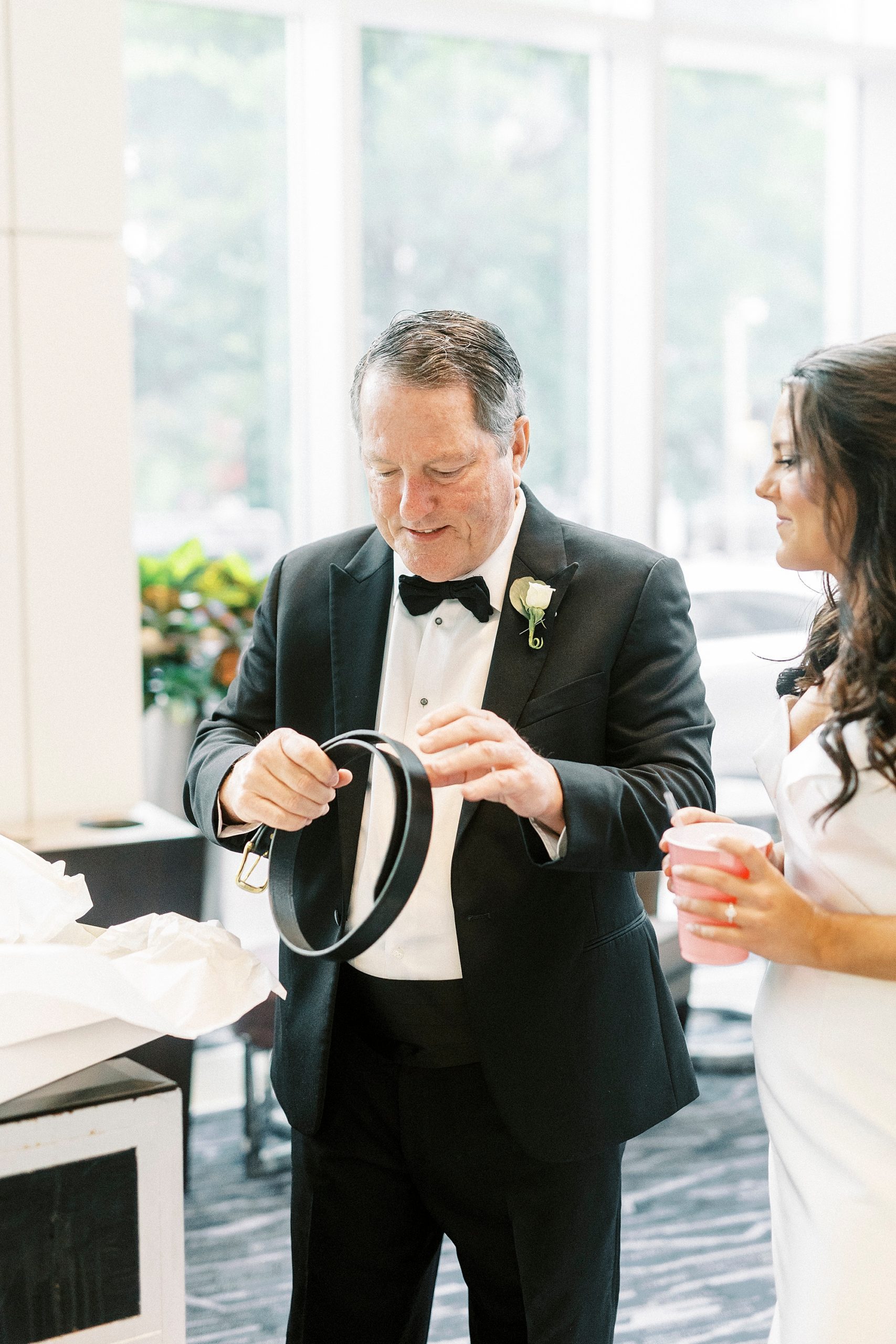 bride gives dad gift during prep at Kimpton Tyron Park