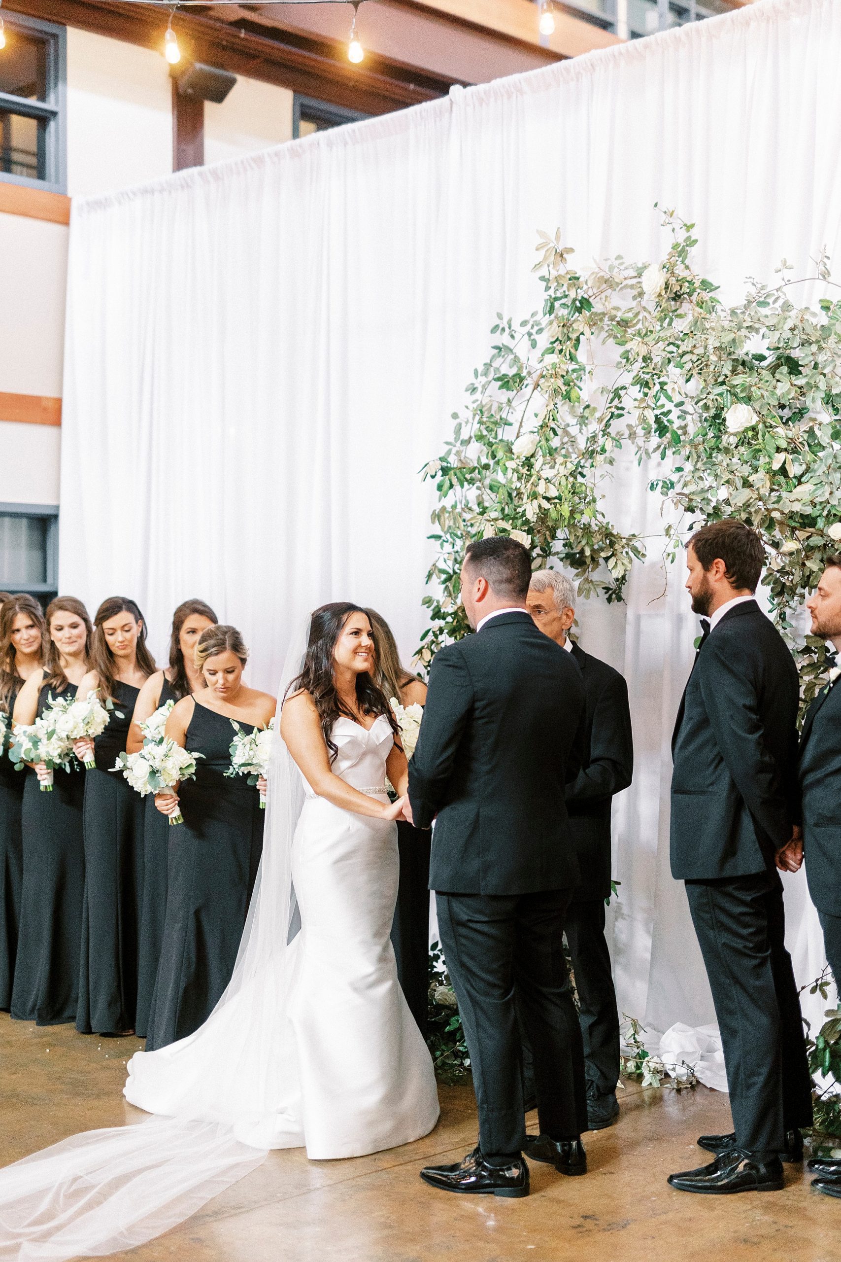 bride and groom exchange vows during Design Atrium ceremony