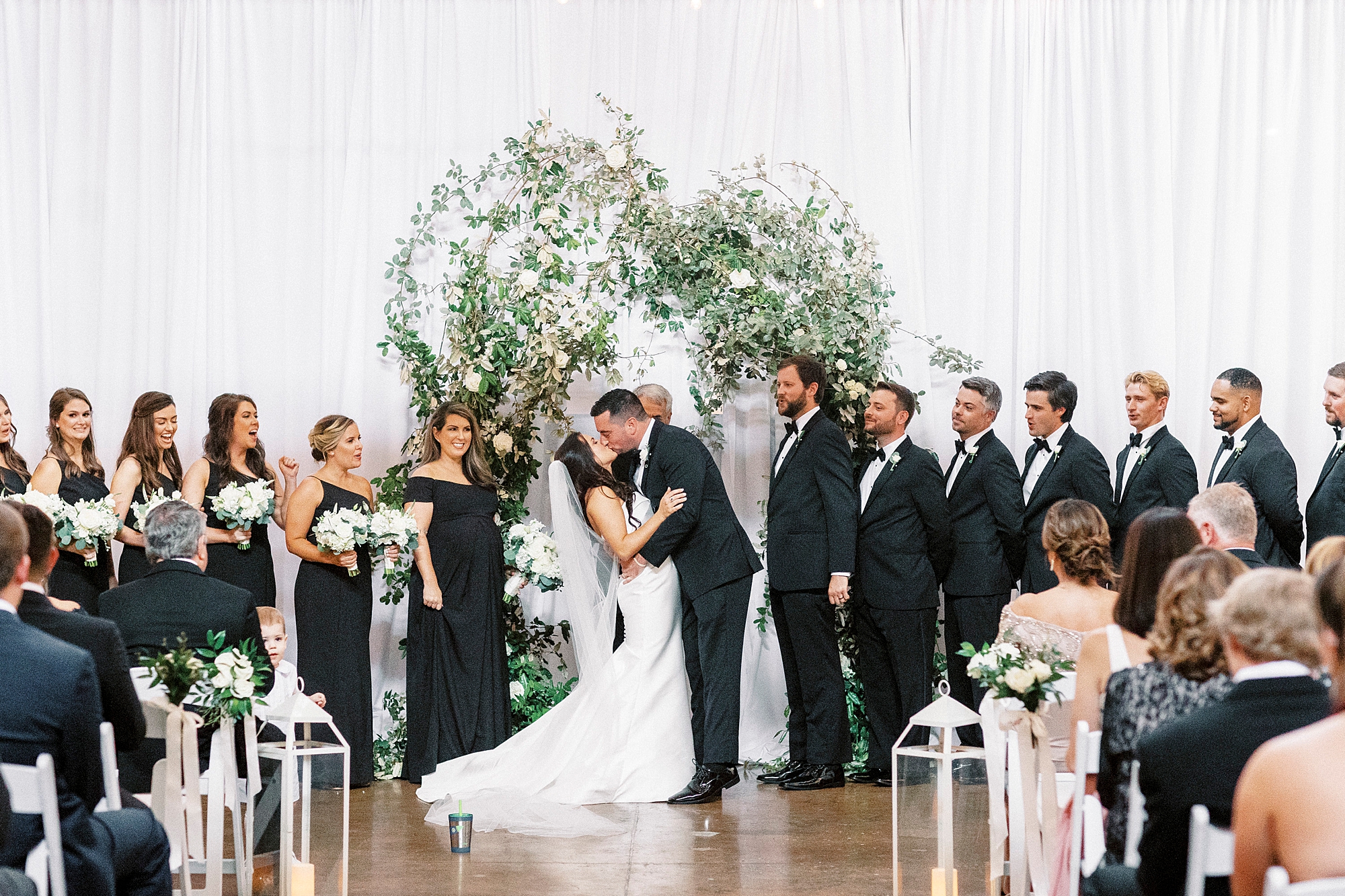 wedding ceremony with greenery arbor at Design Atrium