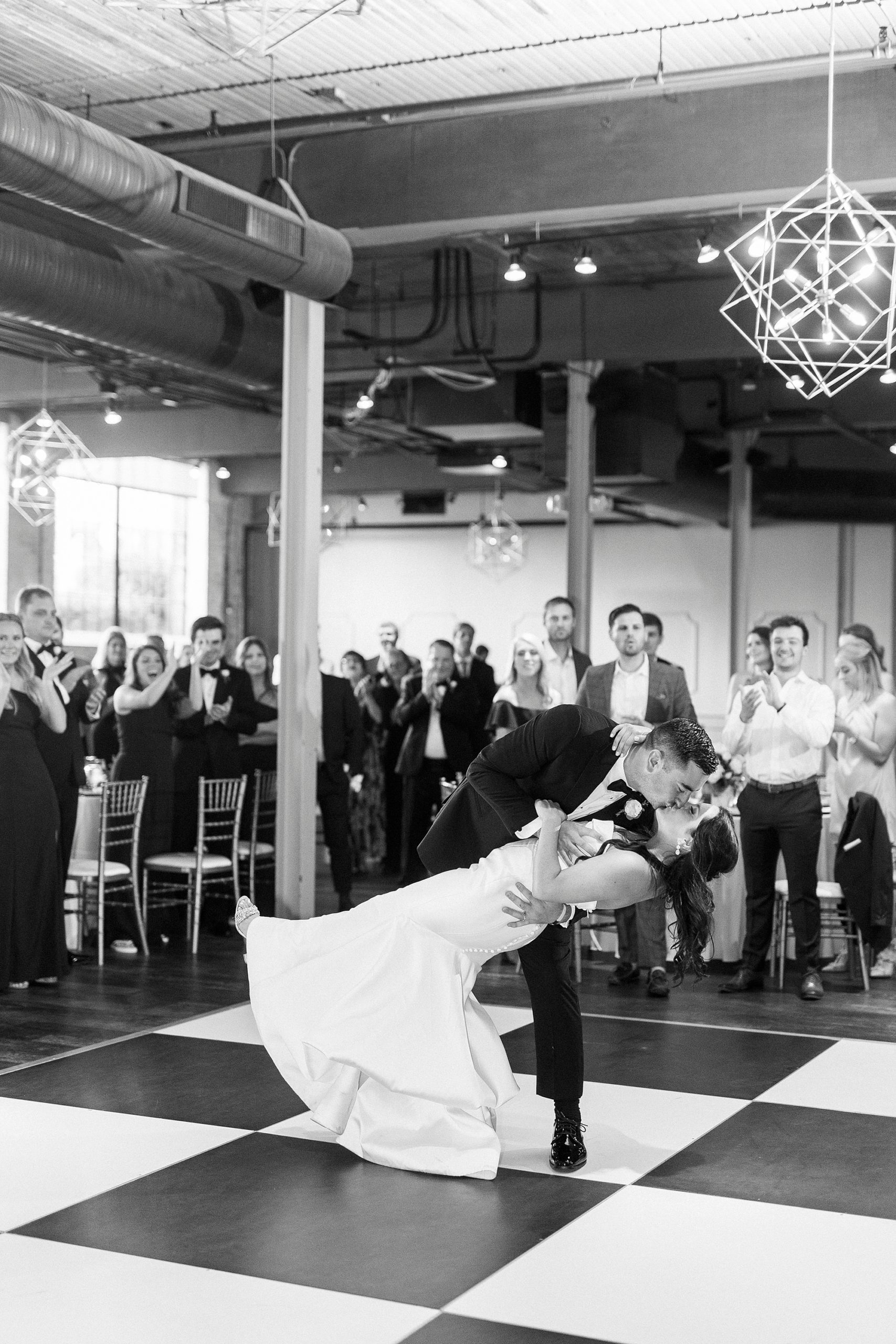 groom dips bride during first dance at Byron's South End