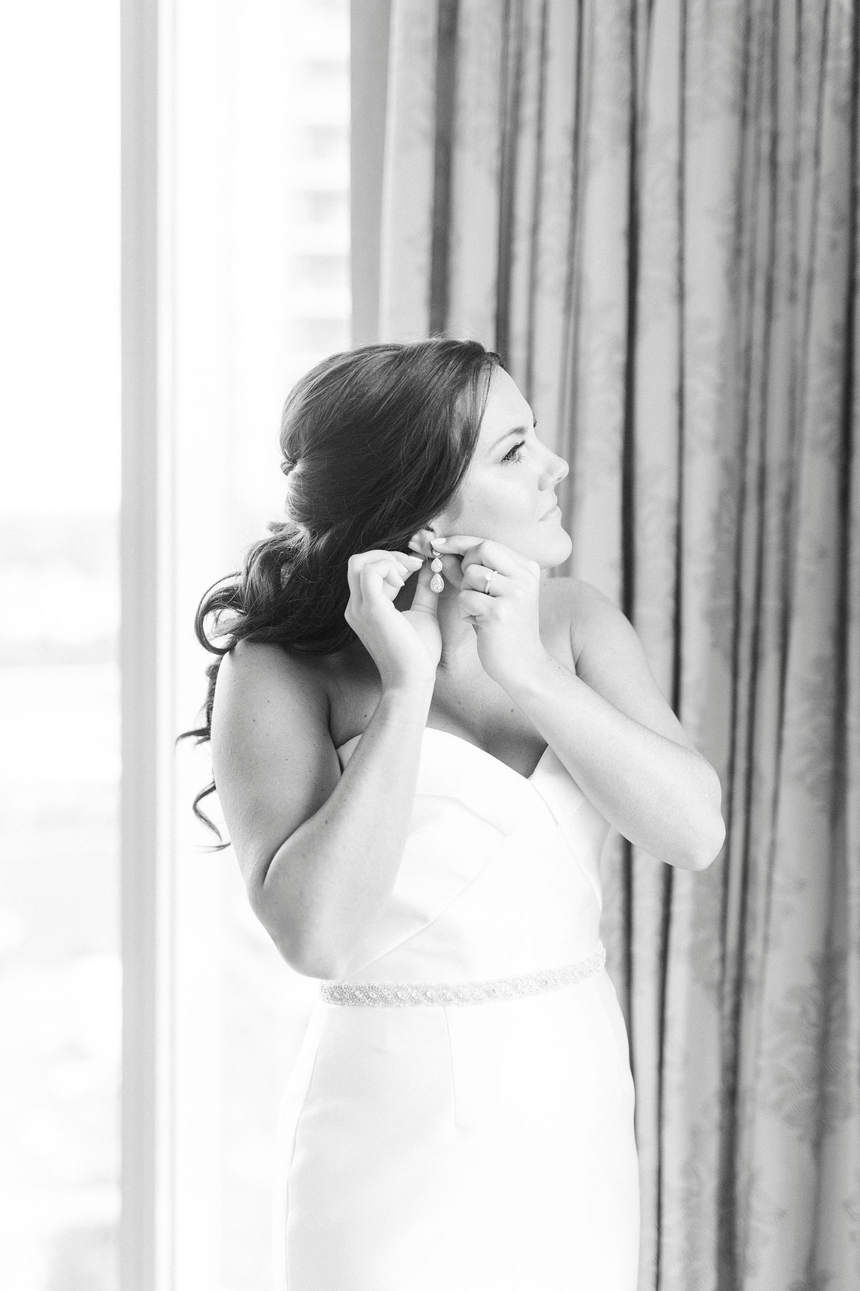 bride adjusts earrings at Kimpton Tyron Park