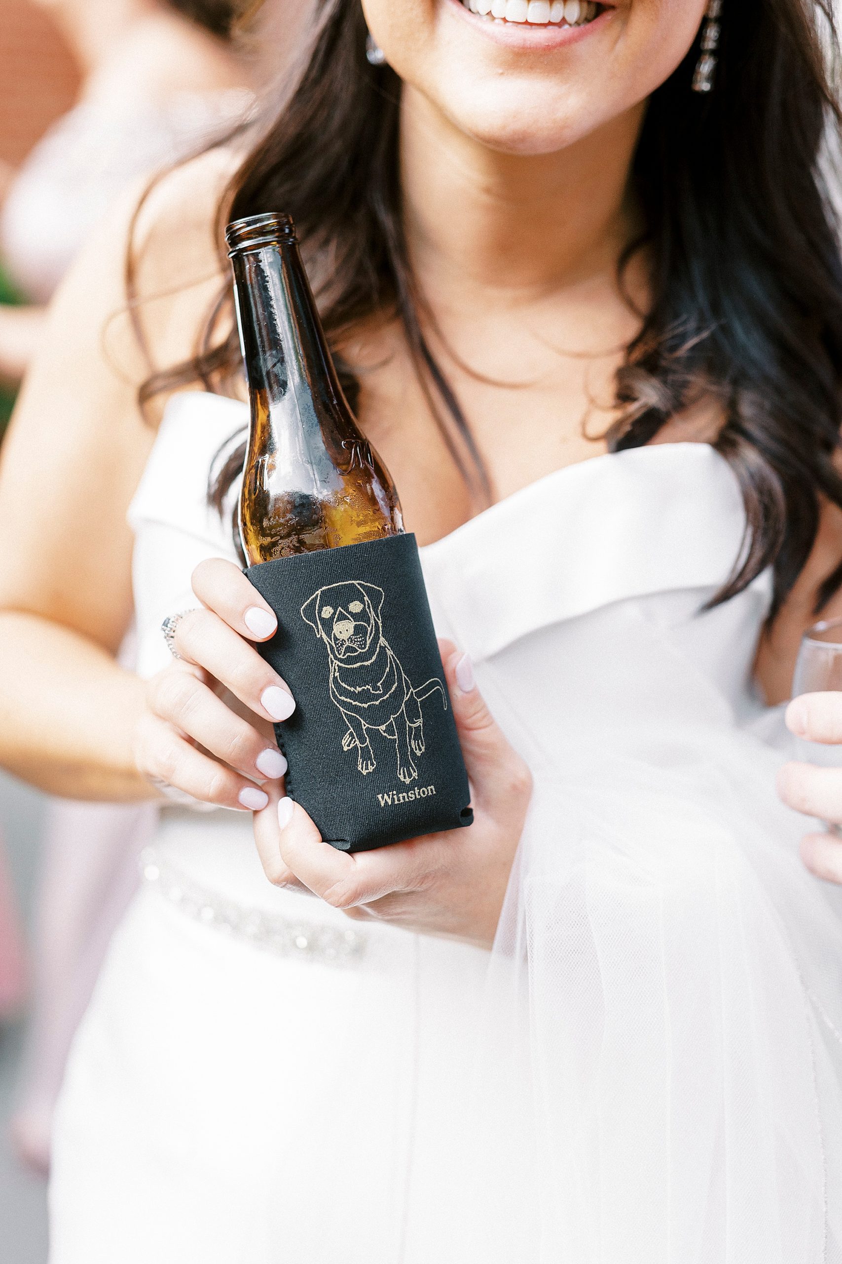 bride holds custom koozie at classic Byron's South End wedding reception