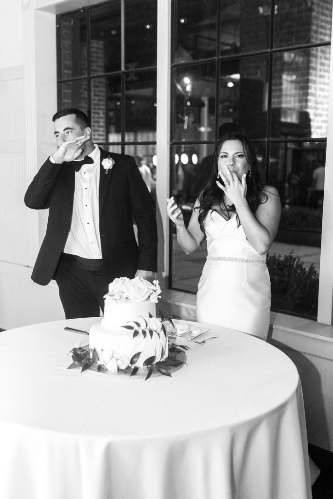 newlyweds last cake during wedding reception at Byron's South End