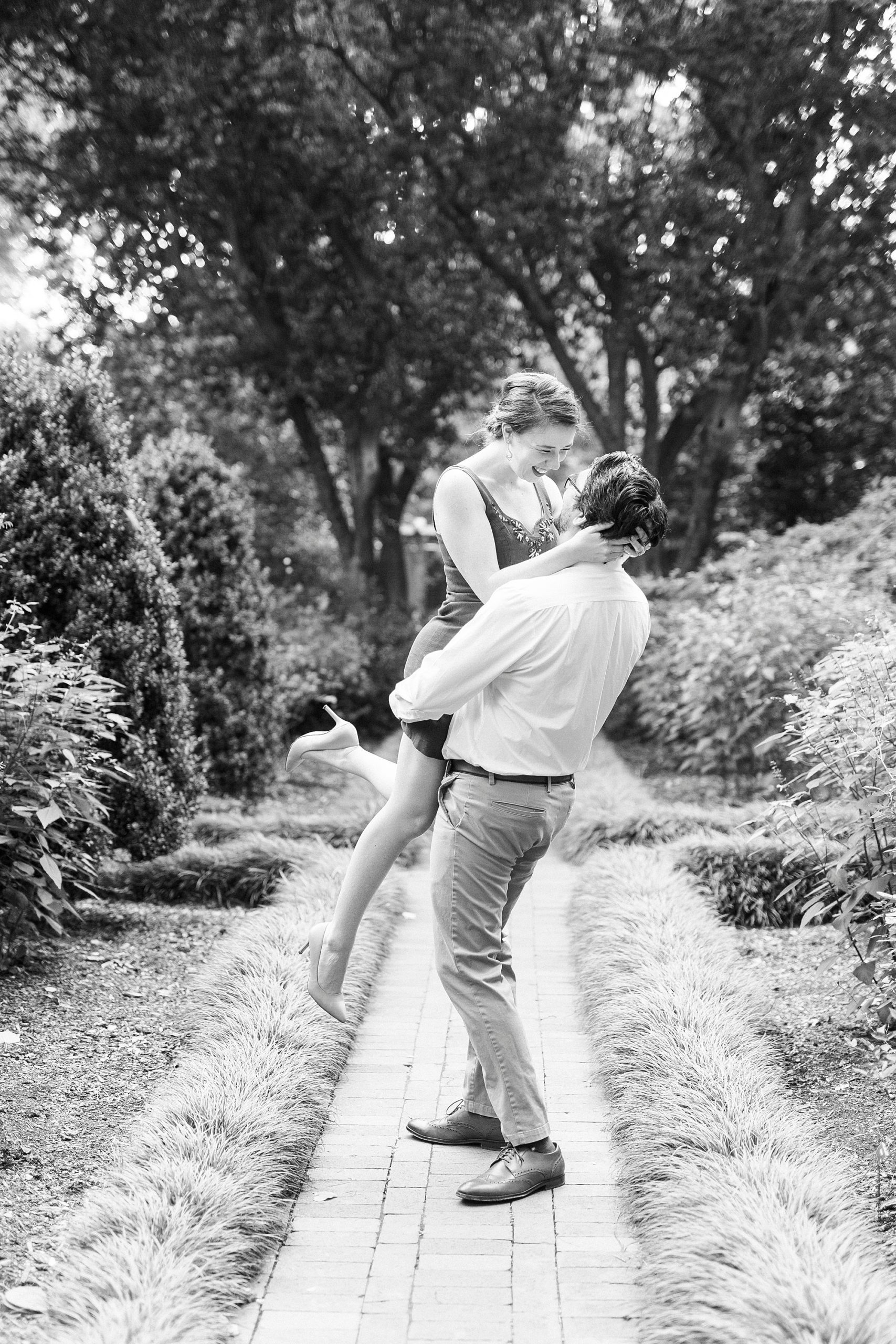 man lifts up wife during Wing Haven Garden anniversary session