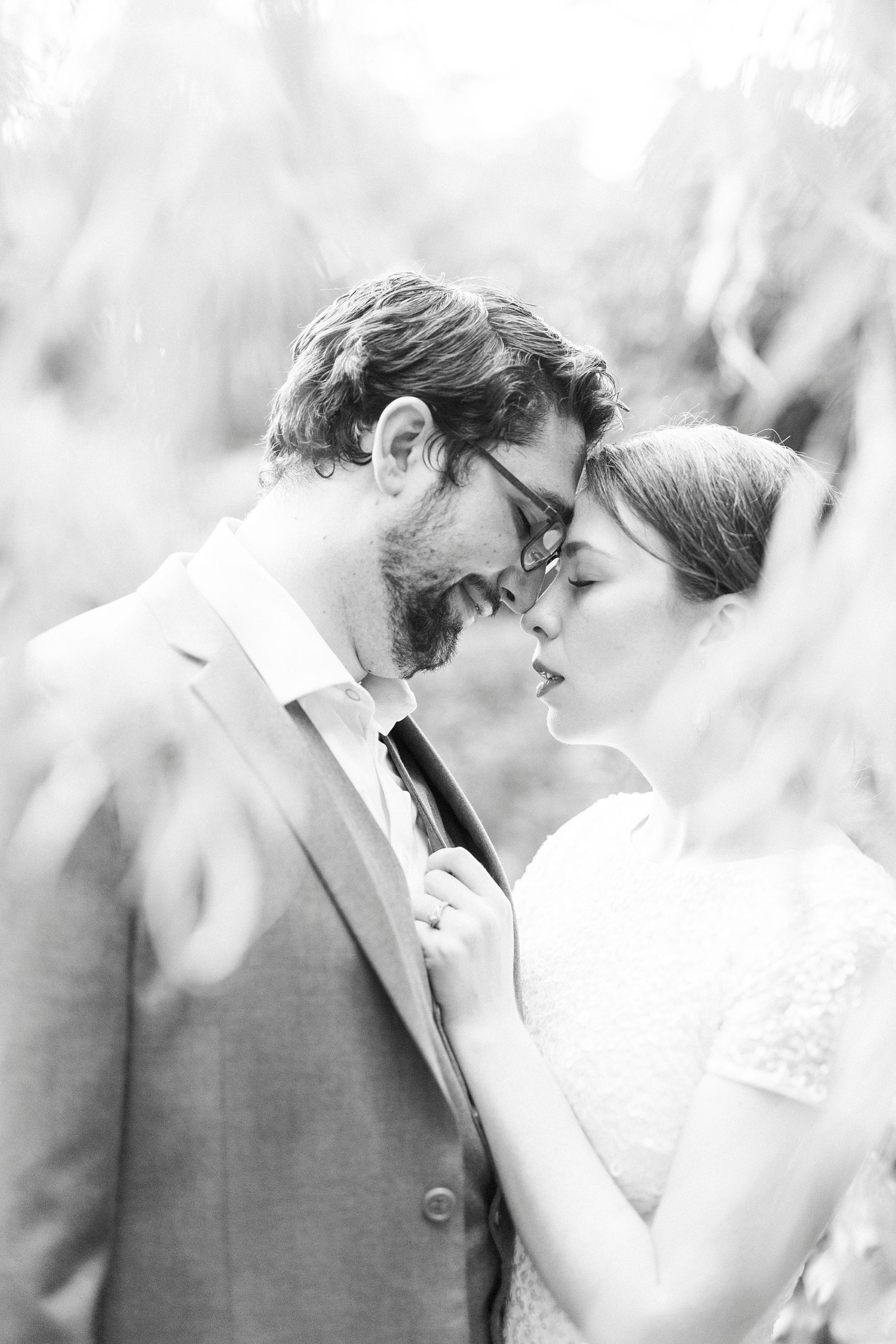 woman leans head together with husband during portraits at Wing Haven Garden