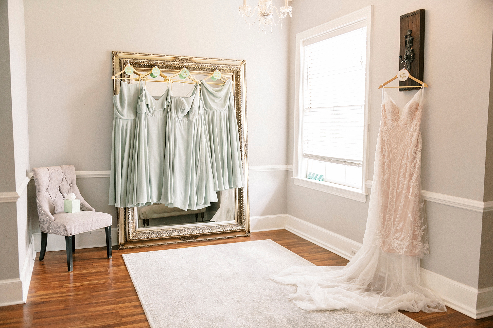 wedding dress hangs in room with bridesmaid gowns at Separk Mansion