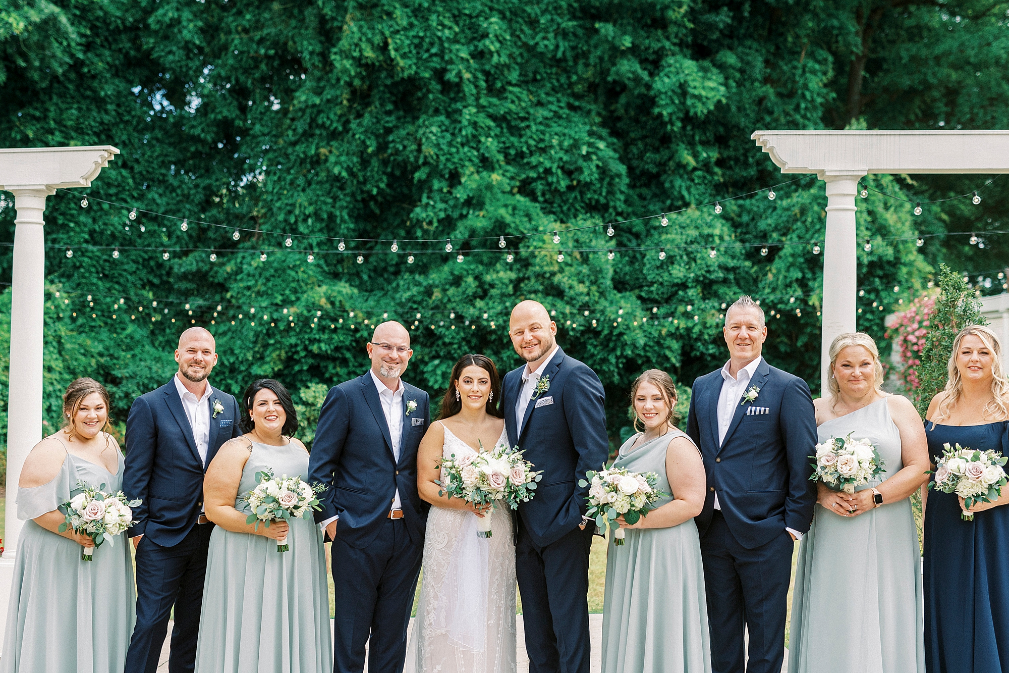 bride and groom stand with wedding party for summer wedding at Separk Mansion