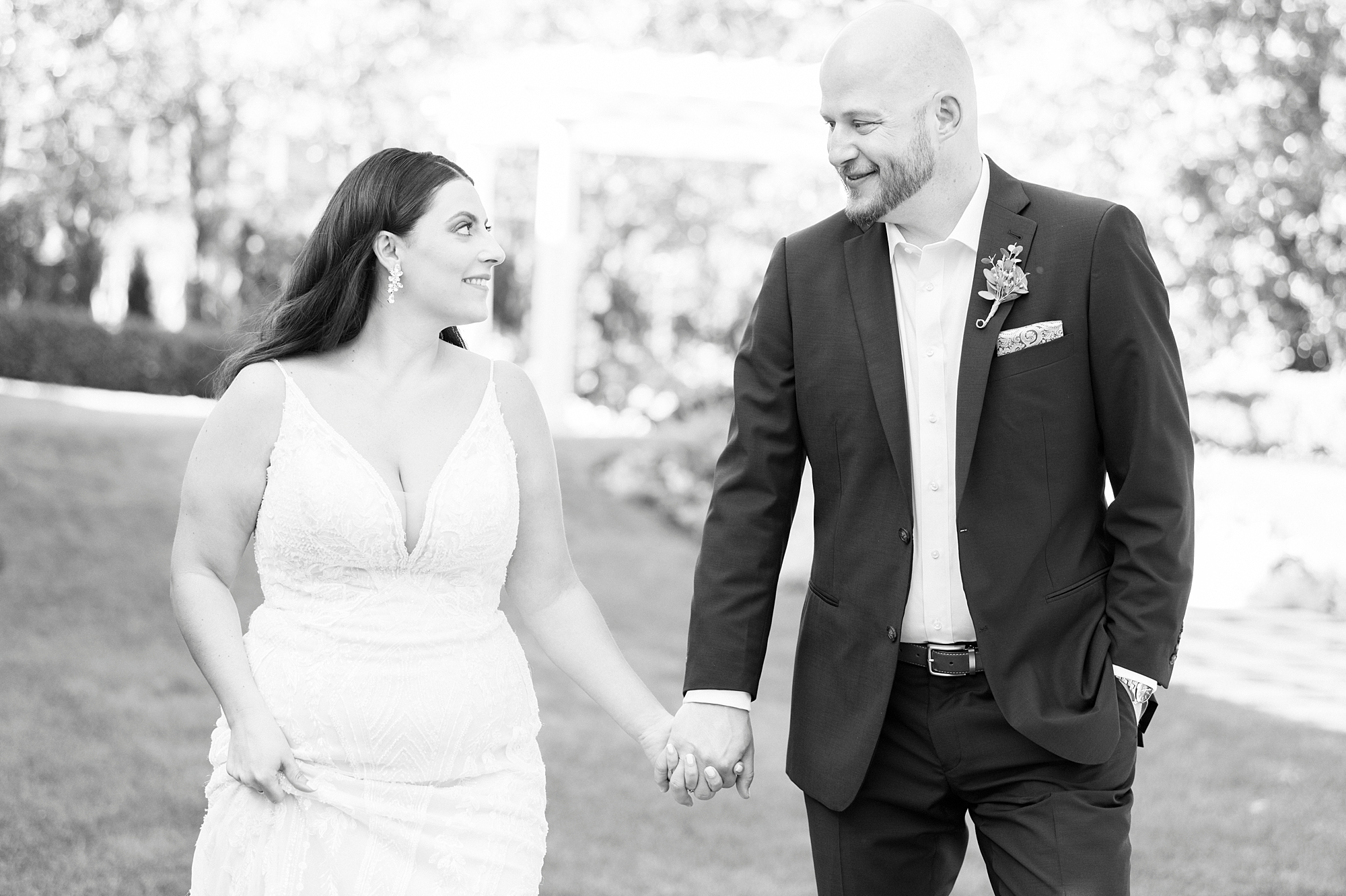 bride and groom hold hands walking on lawn at Separk Mansion